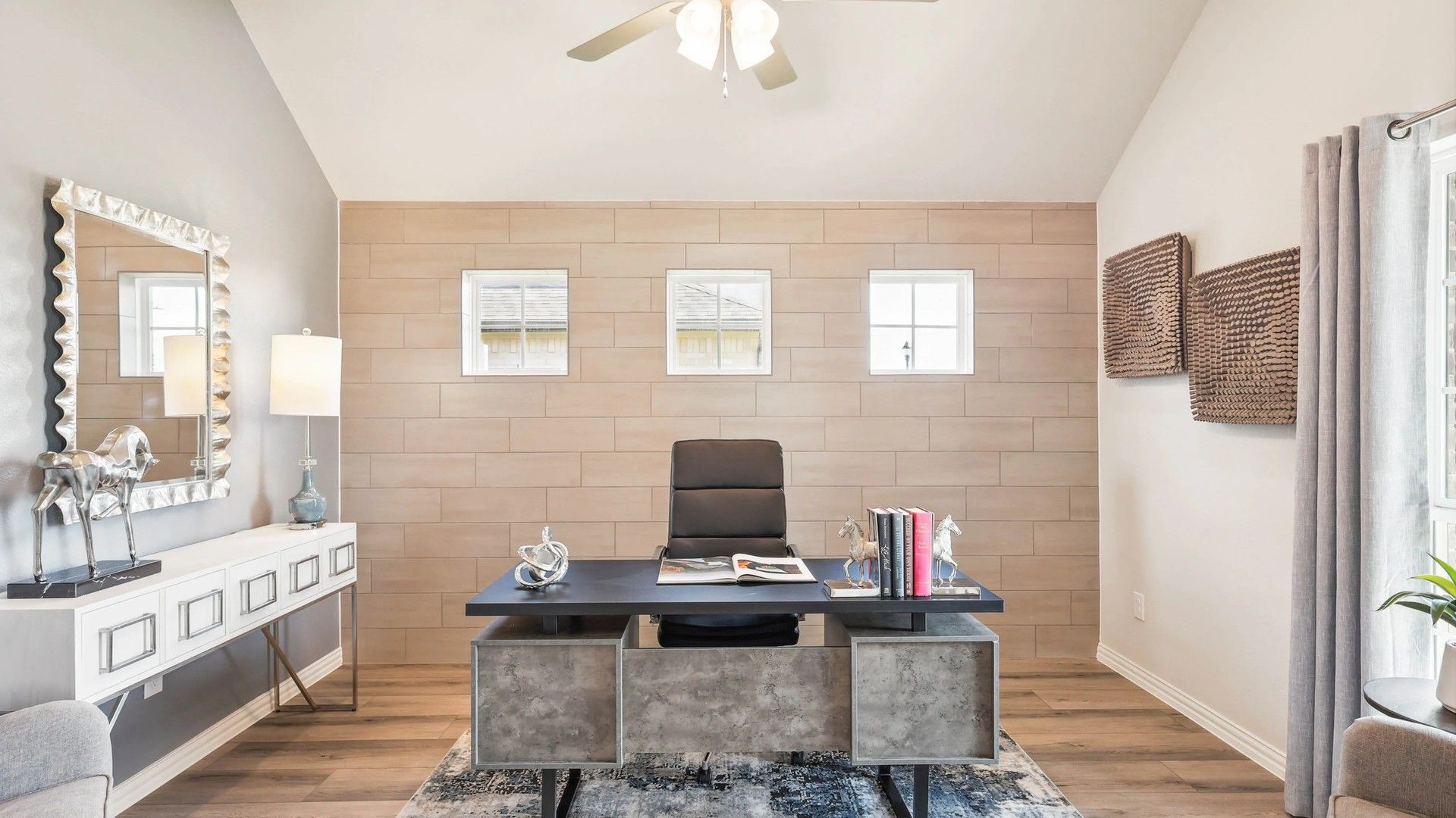 Stunning accent wall and sleek furniture enhance this elegant Pebblebrook office space.