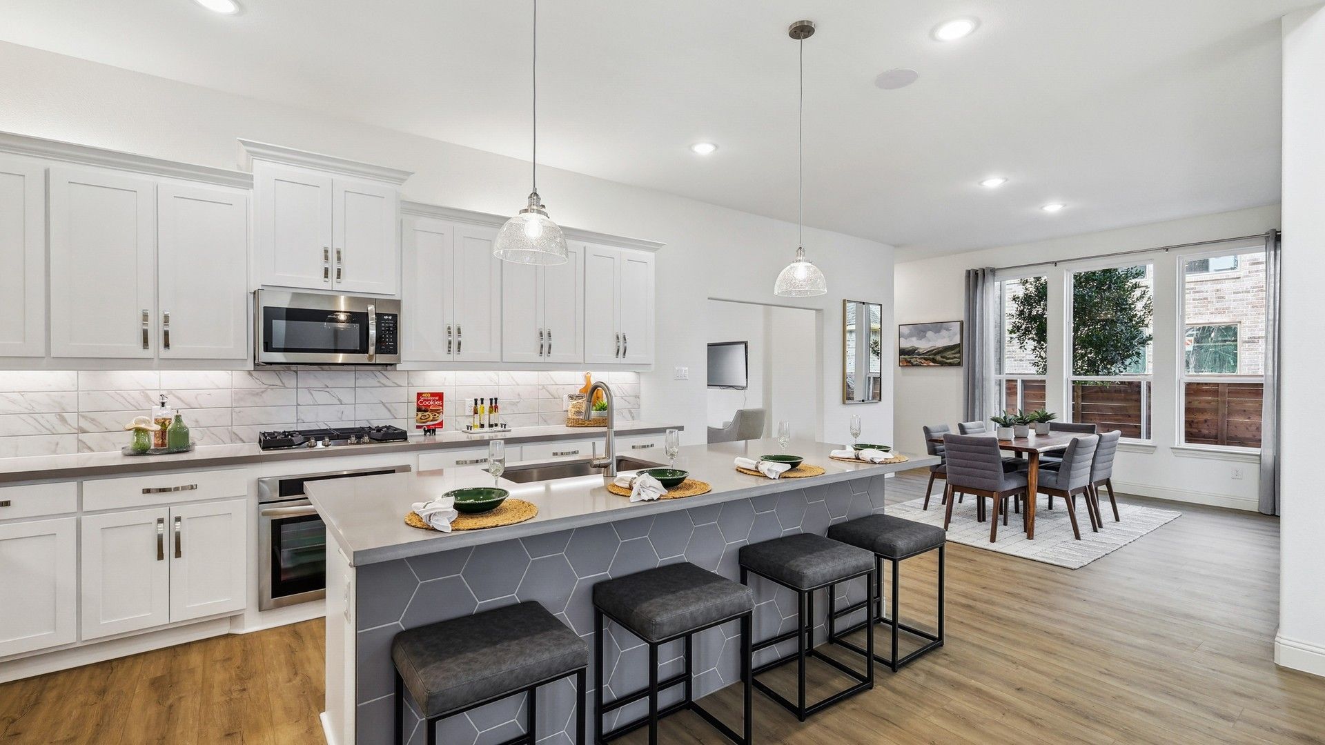 Elegantly designed with hexagon tile island and chic pendant lighting, this Solterra kitchen offers luxury and style.