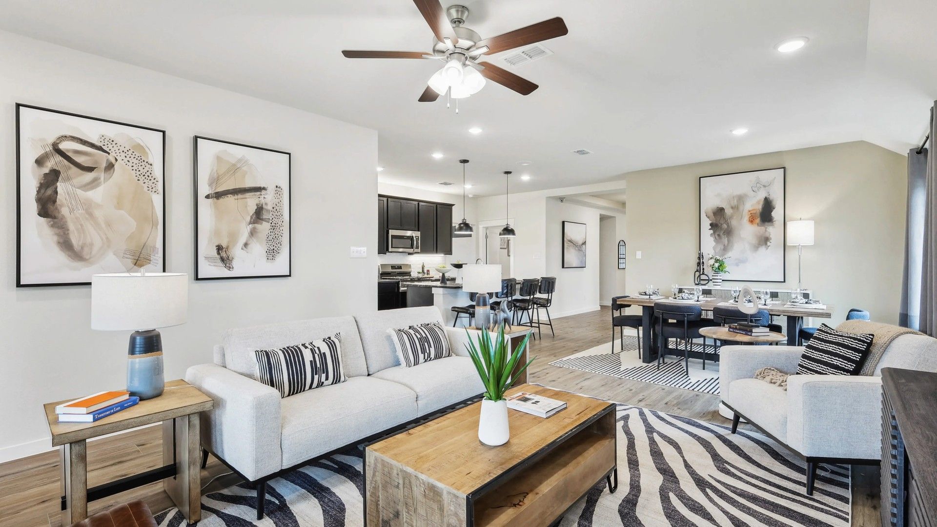 Spacious Simpson Crossing room features chic decor, wooden floors, and abstract art for luxurious living.