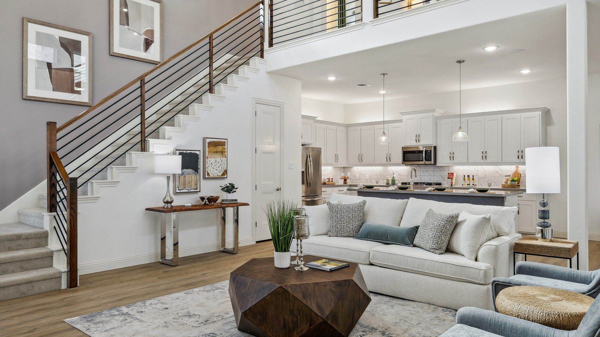 Exquisite open-plan layout with sleek staircase and airy kitchen in Solterra, Texas home.