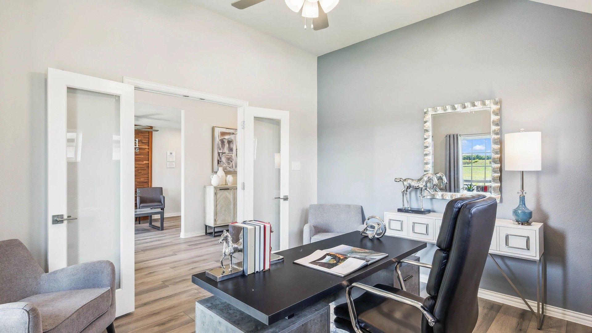 Luxurious Pebblebrook office featuring sleek glass doors, refined wood flooring, and contemporary decor.
