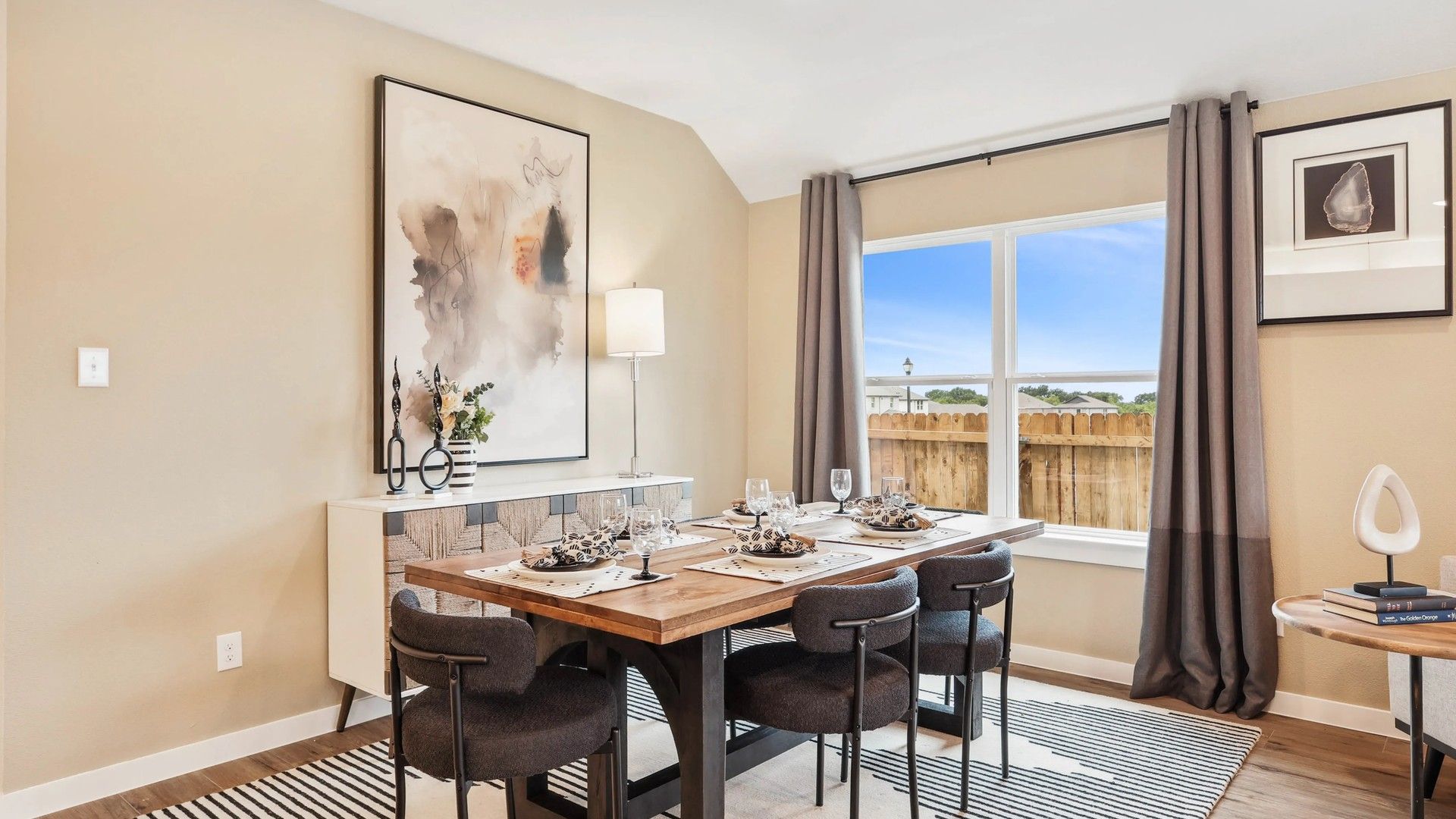 Experience refined dining with sleek modern furniture, abstract artwork, and expansive windows at Simpson Crossing.