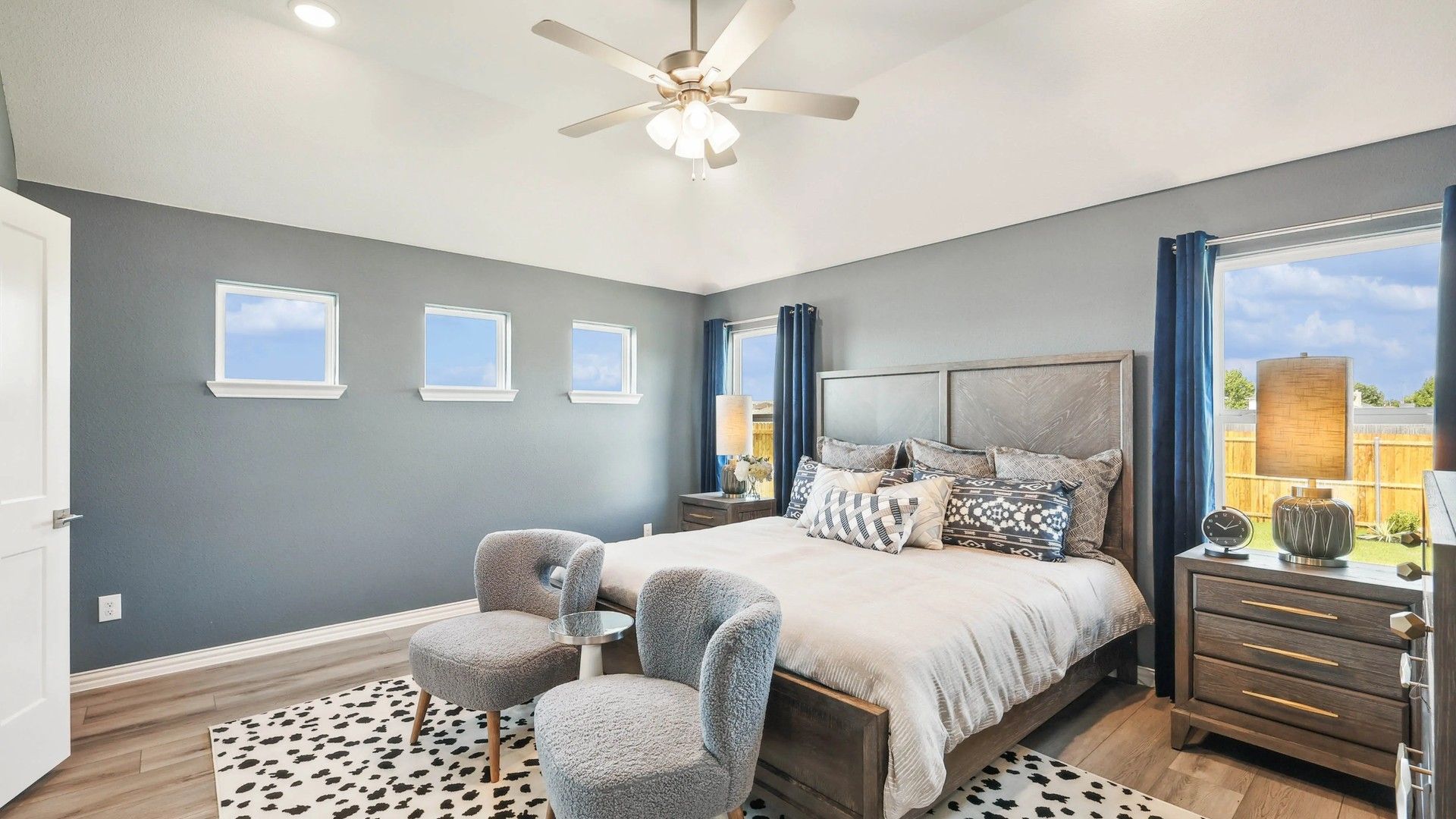 Experience serene sophistication with plush bedding, chic accents, and natural light in Pebblebrook's luxury bedroom.