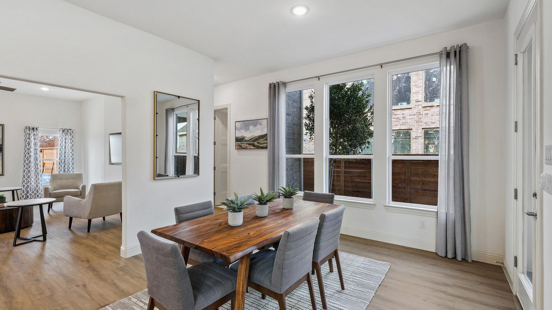 Experience luxury with floor-to-ceiling windows and exquisite hardwood flooring in Solterra, Texas.