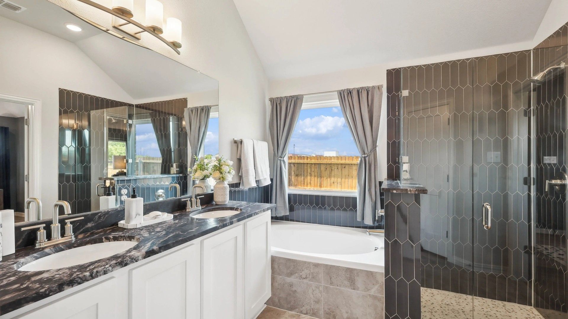 Stunning Pebblebrook bathroom features marble countertops, dual sinks, and a sleek glass shower.
