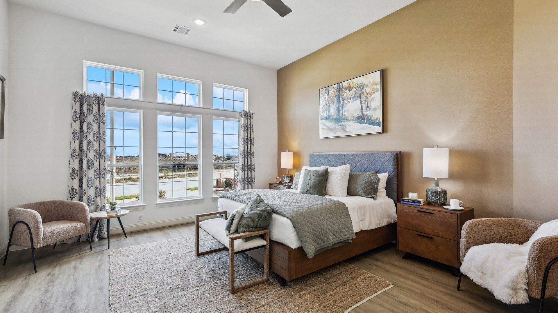 Expansive windows, plush textiles, and sleek hardwood define this discerning Solterra, Texas bedroom.