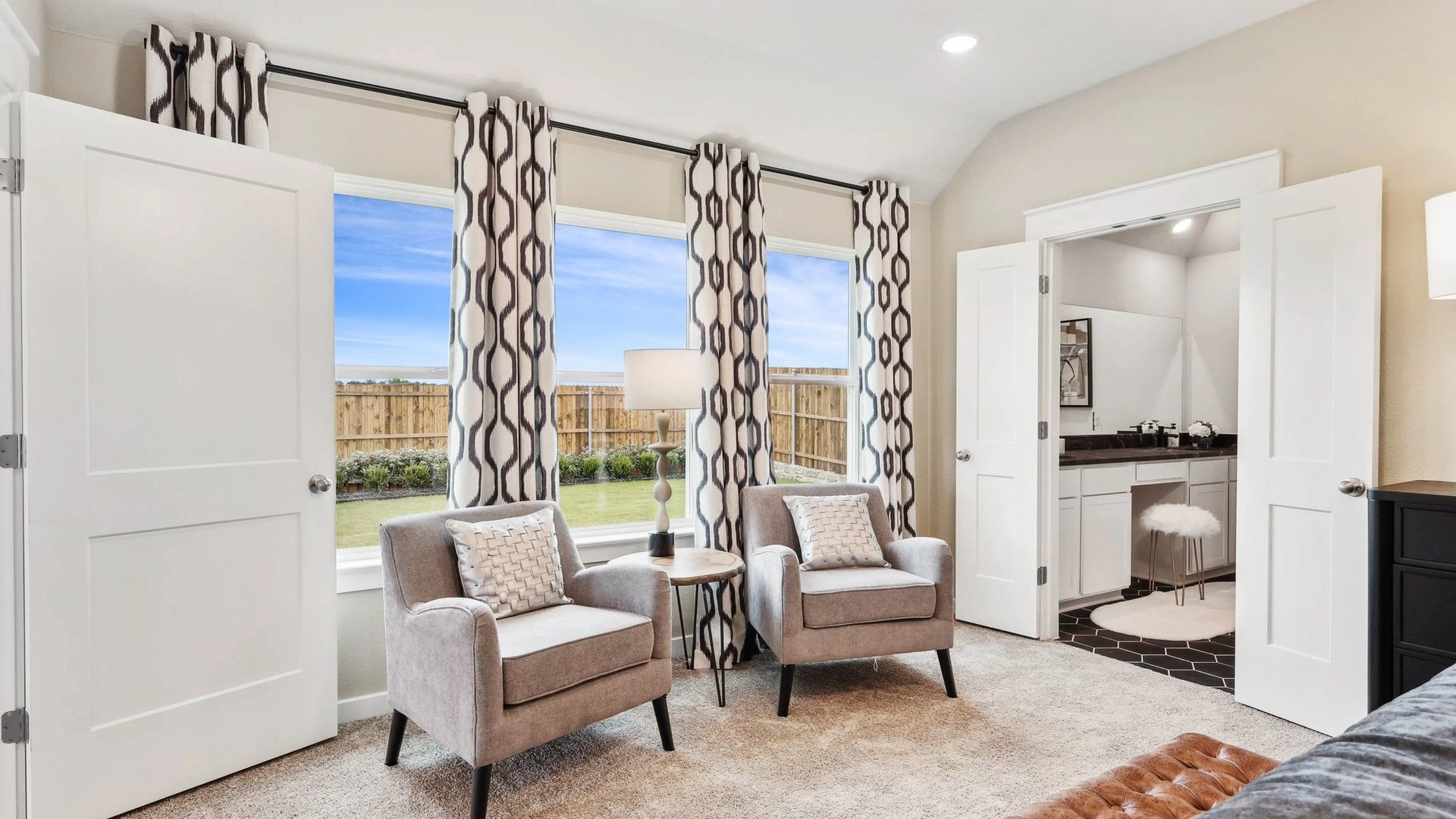 Elegant living space featuring plush carpet, geometric curtains, and seamless outdoor views in Simpson Crossing.