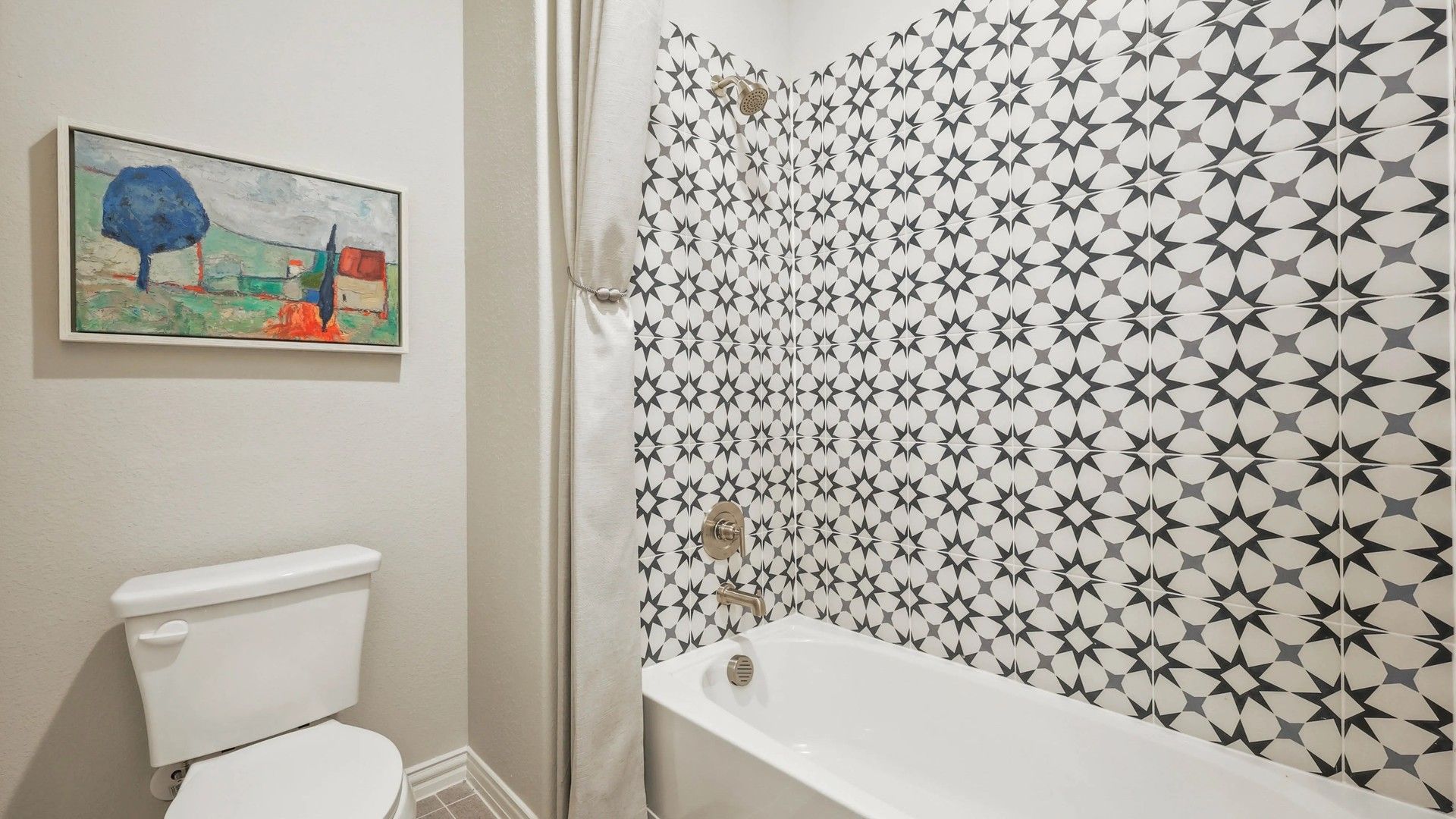 Exquisite Pebblebrook bathroom features striking geometric tiles and elegant fixtures, embodying sophisticated design.