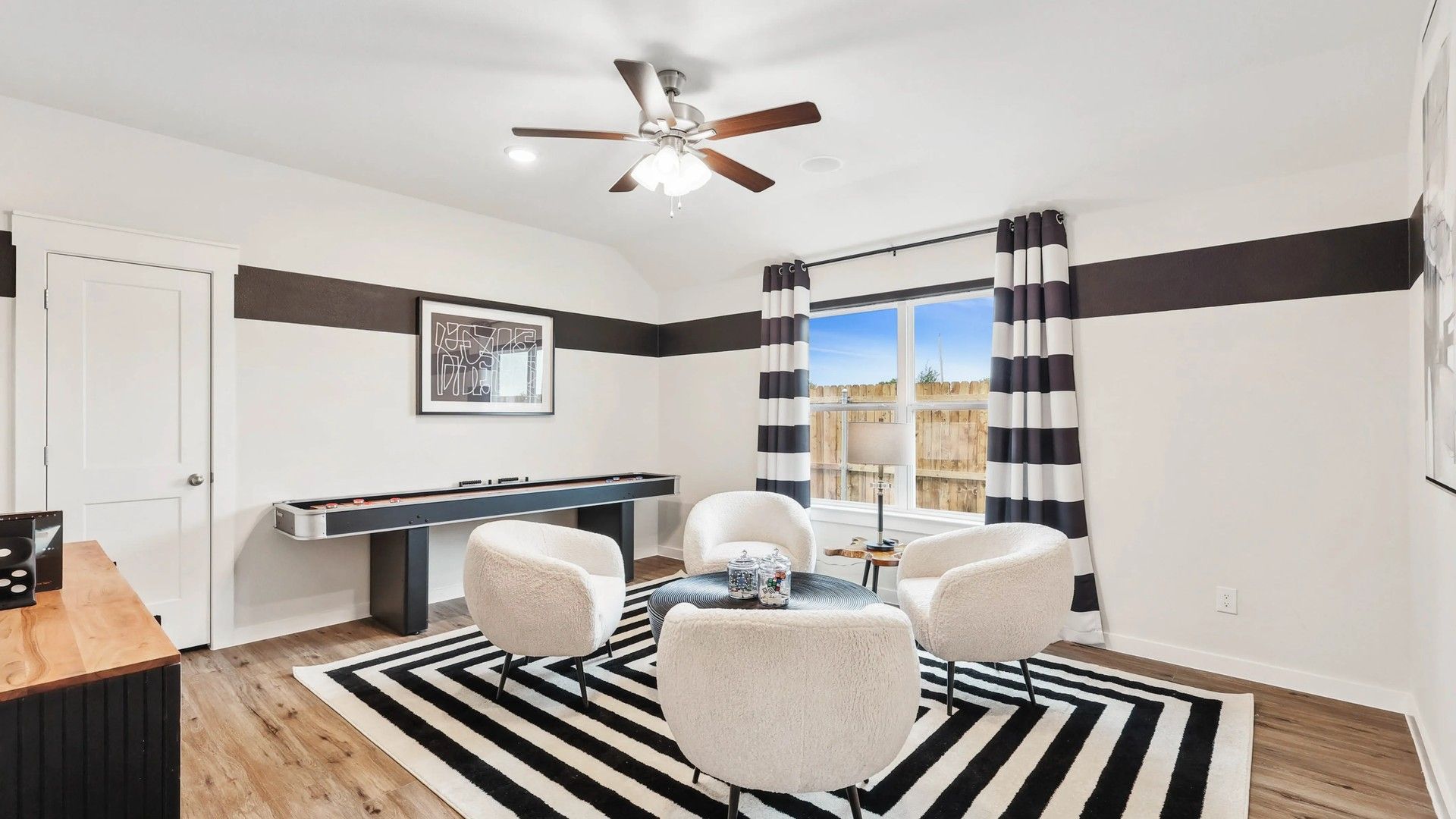 Elegant window and modern decor define this Simpson Crossing living room's allure.