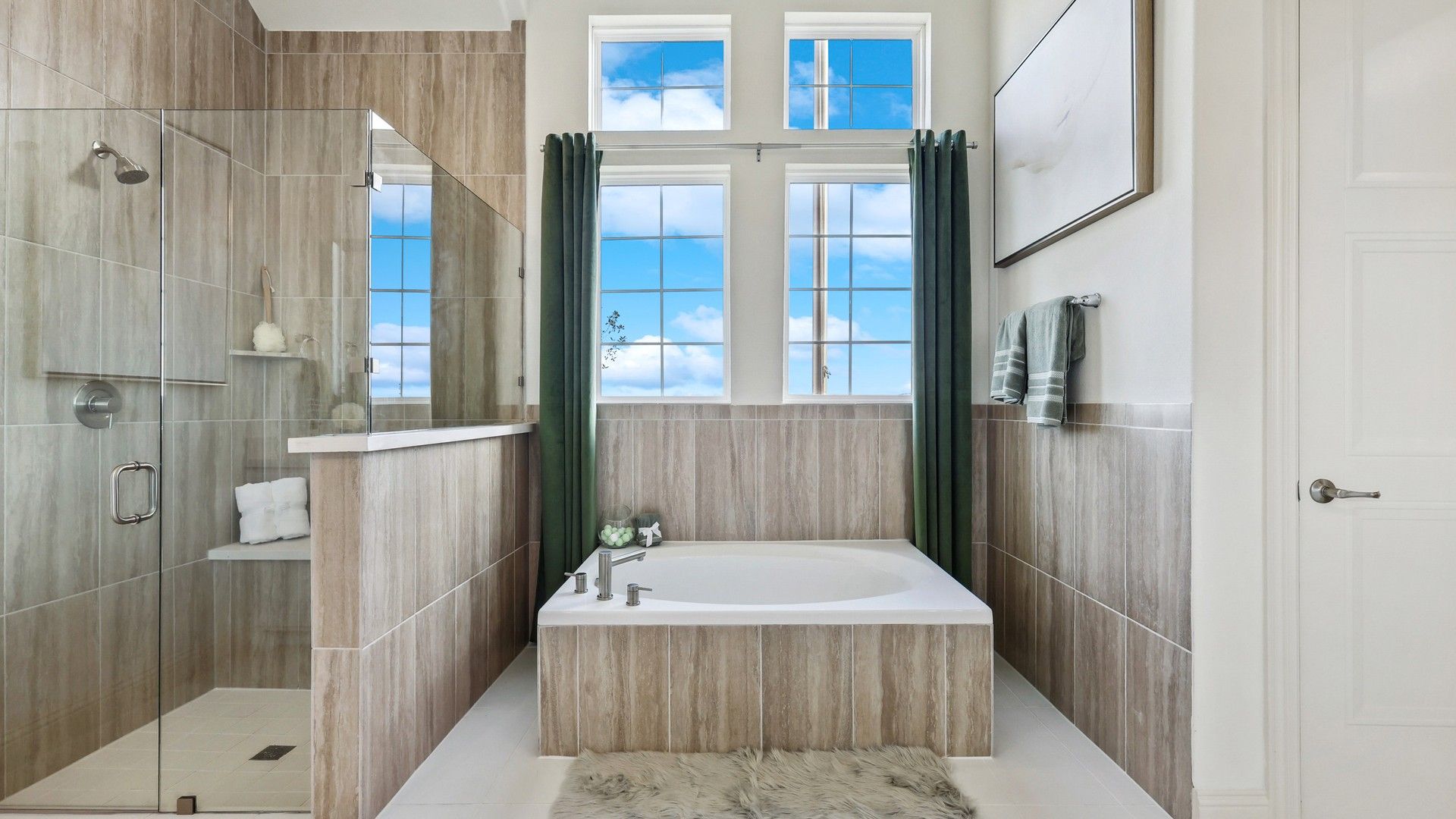 Experience opulence with glass-enclosed shower, jetted tub, and sky-lit windows in Solterra, Texas.