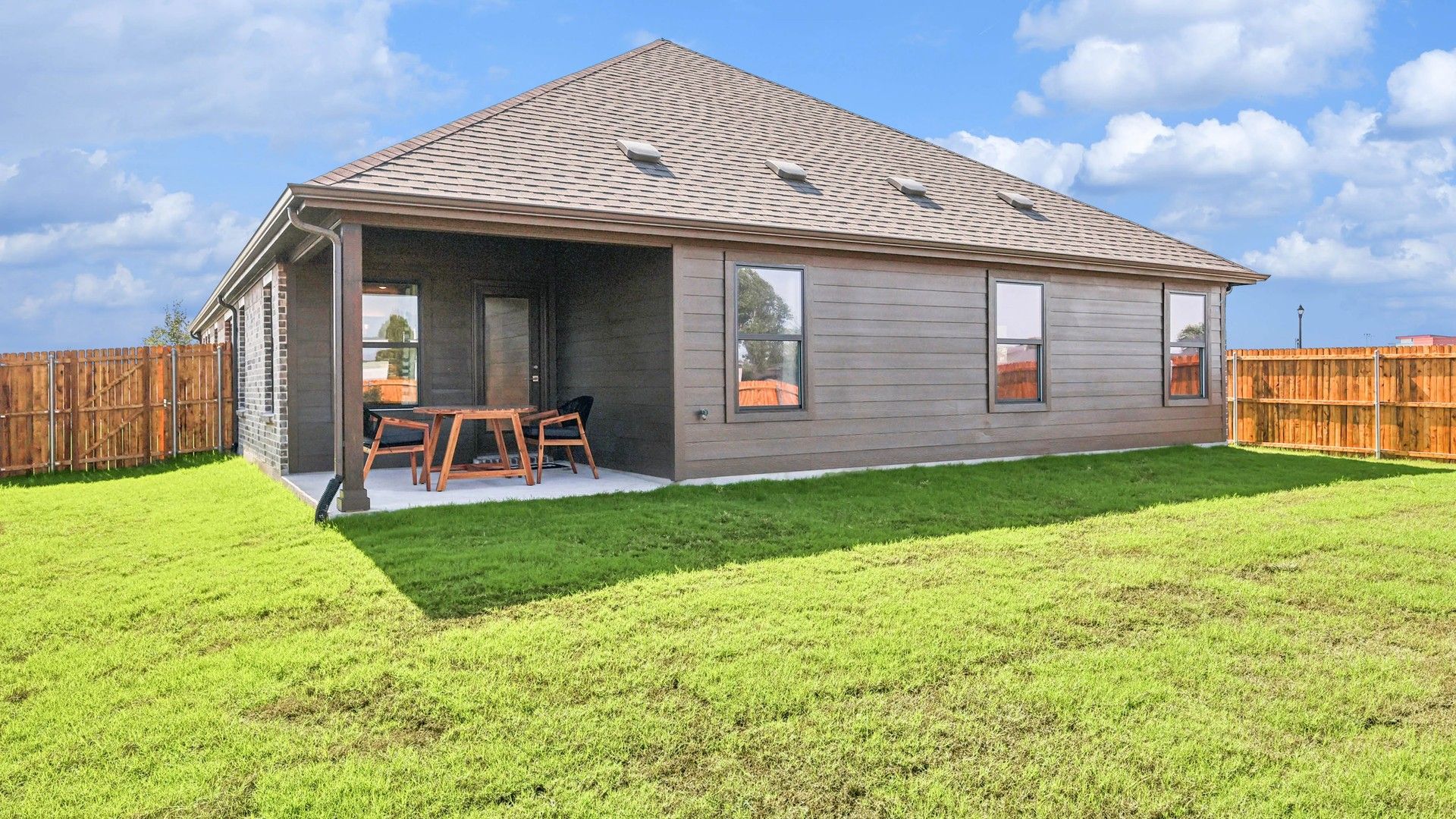 Enjoy the elegant wood siding and covered patio in Pebblebrook's lush backyard setting.
