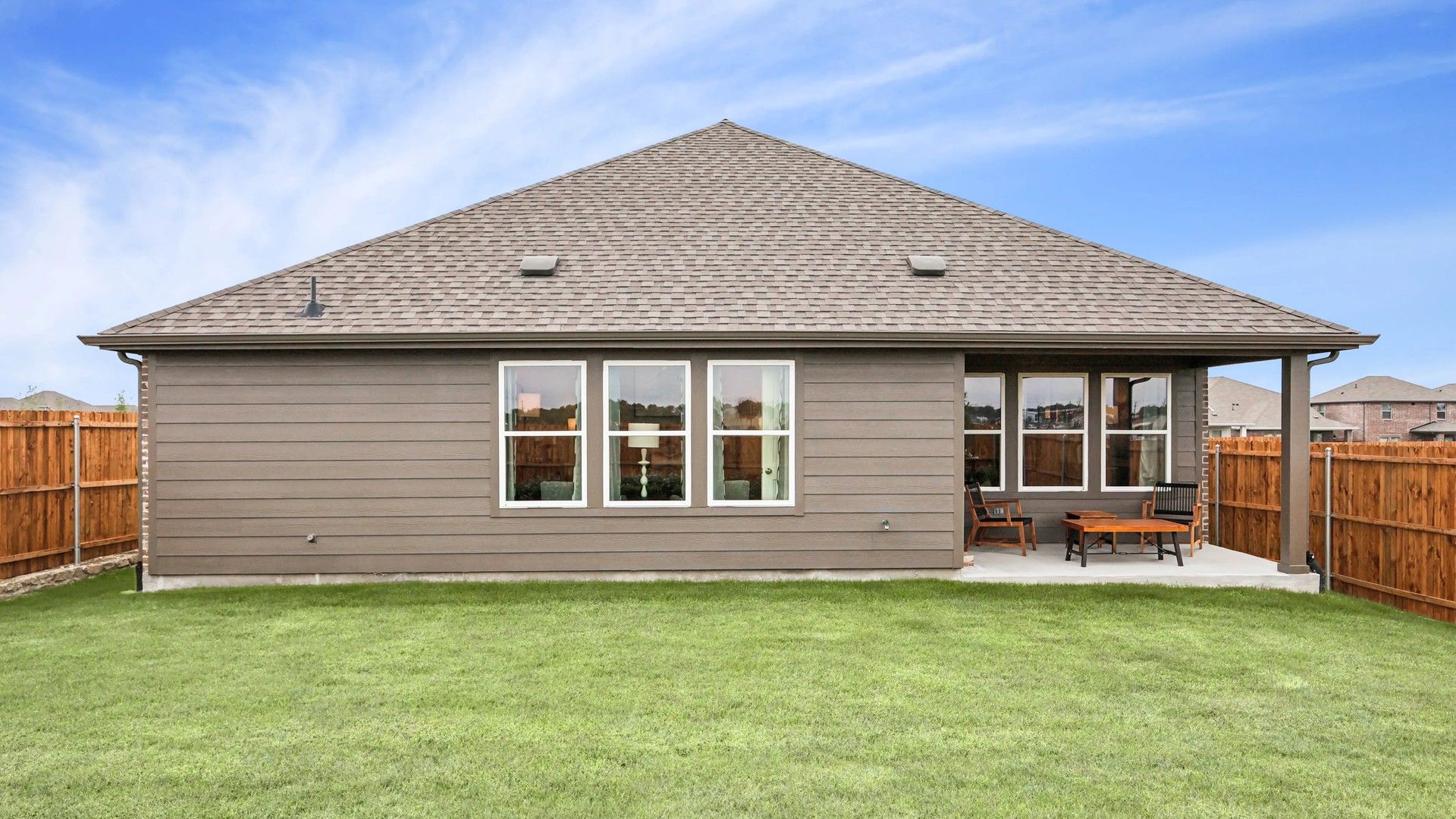 Elegant gable roof design and expansive patio in Simpson Crossing. Enjoy tranquility and privacy in a fenced backyard.