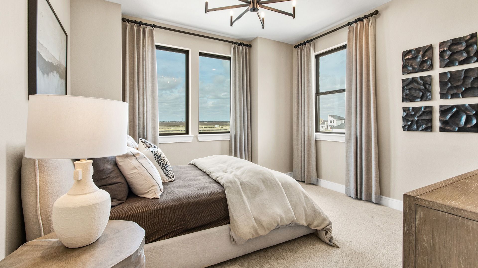 Sunlit windows bring a warm, airy feel to this secondary bedroom in Bridgeland Central.