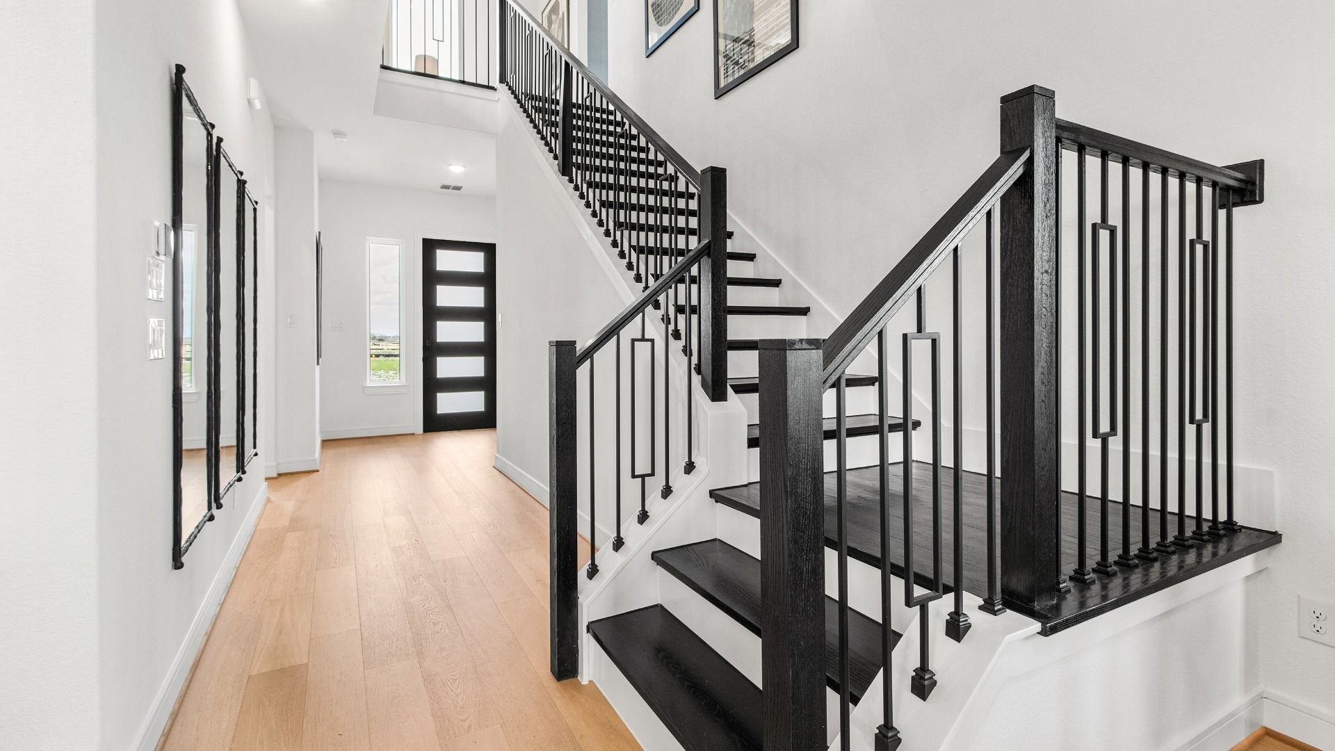 White walls and a dark staircase create a bold modern contrast in this Bridgeland Central home.