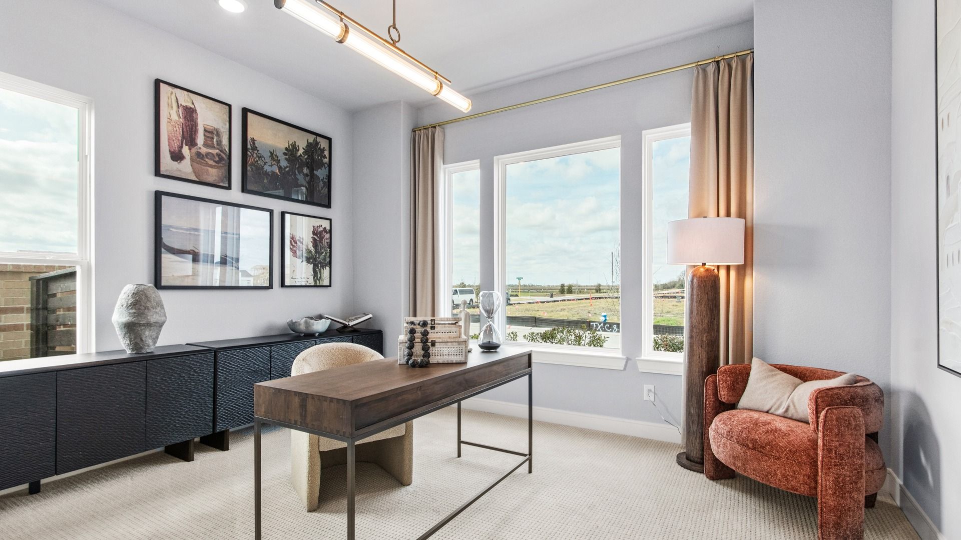 Bright home office in Bridgeland Central with large windows and modern lighting.
