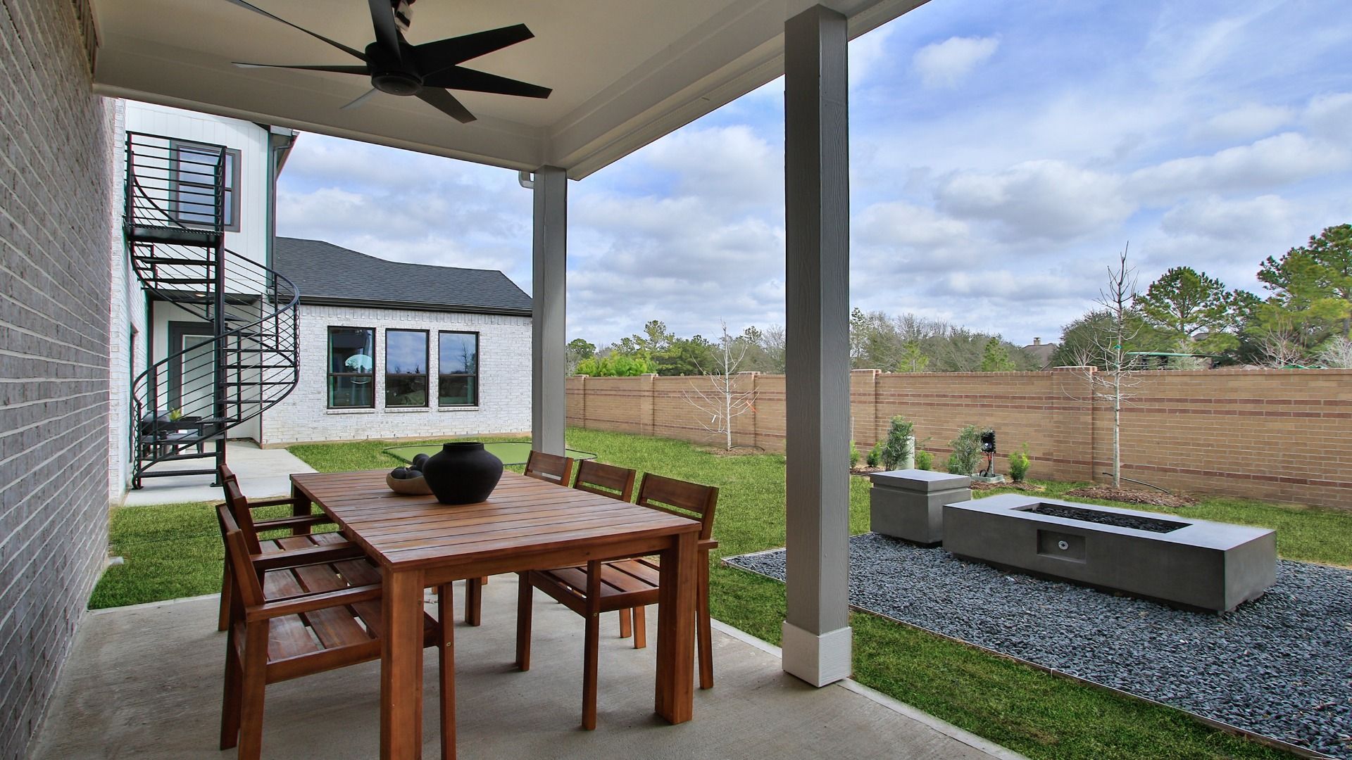 This backyard in Bridgeland Central features a covered patio and built-in fire feature.