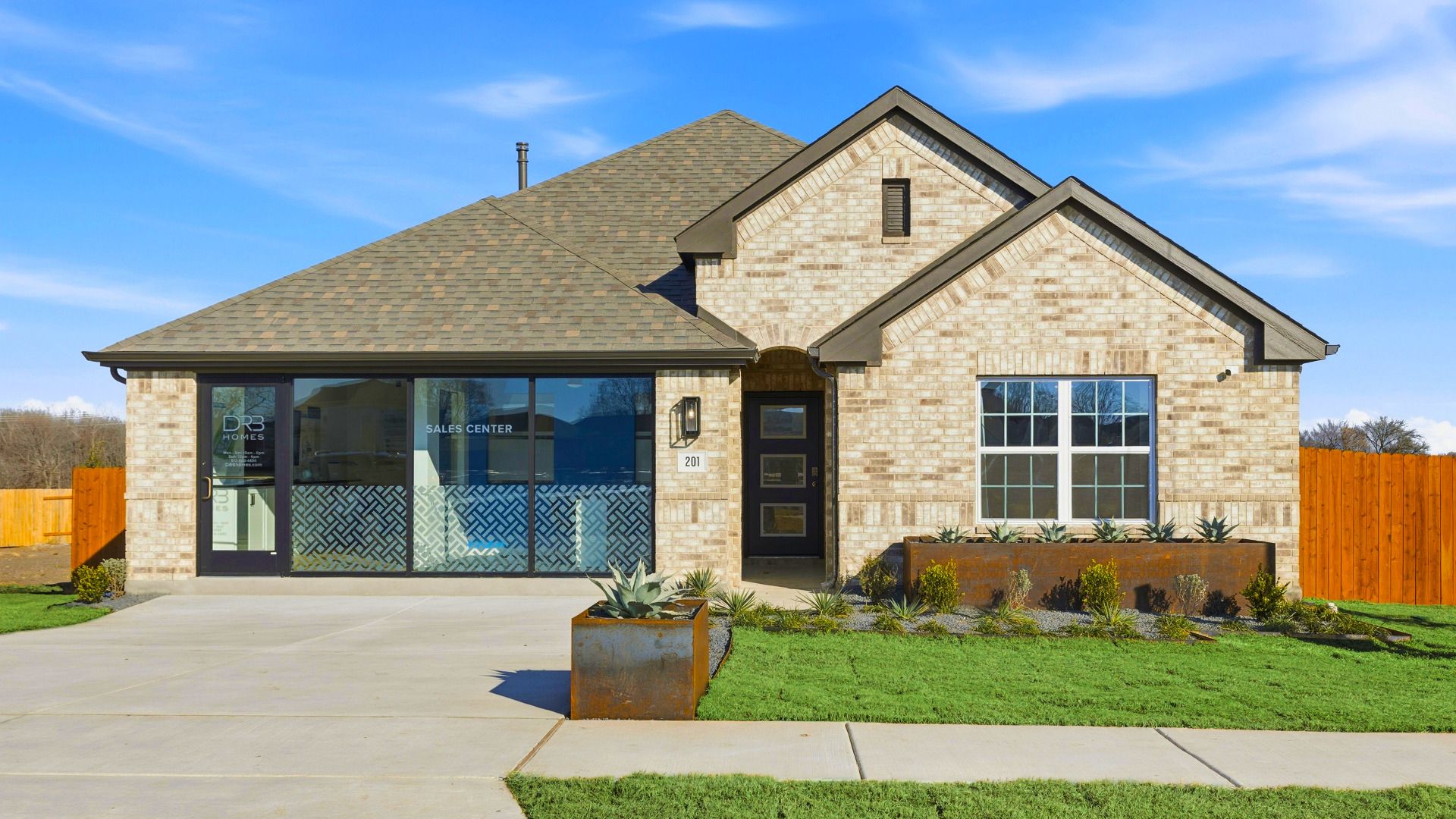Experience elegance with this Infinity Square home featuring exquisite brickwork and a gabled roof.