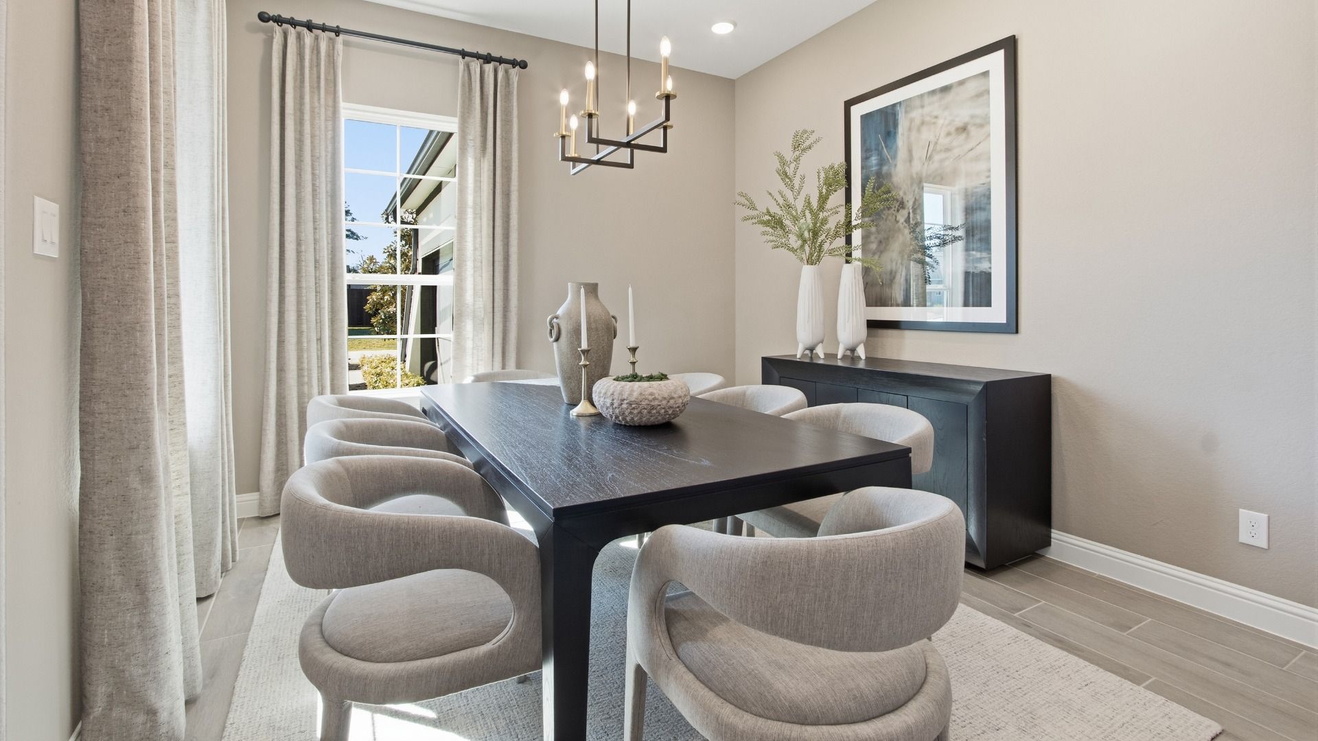 Revel in the luxury of expansive windows and chic chandeliers in Mostyn Manor Reserve's elegant dining room.