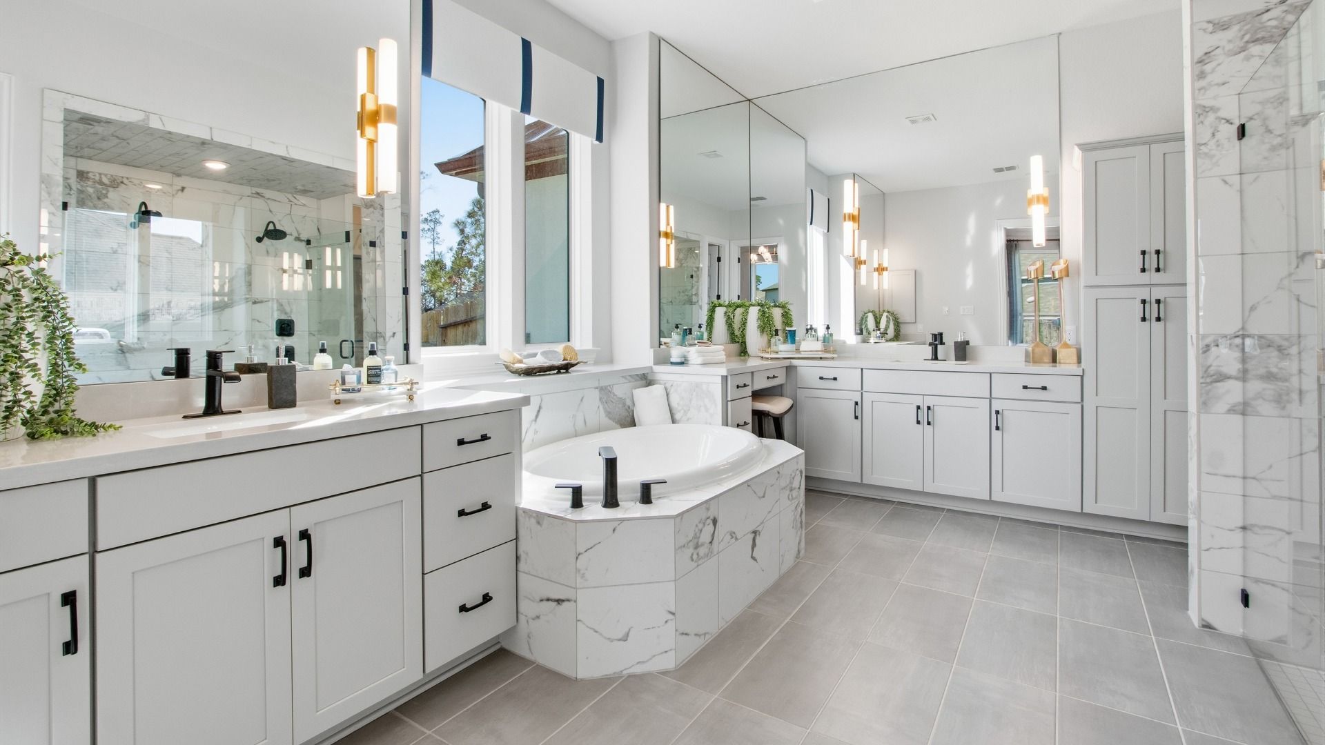 Indulge in marble elegance with a grand soaking tub, designer lighting, and ample natural light in Mostyn Manor Reserve.
