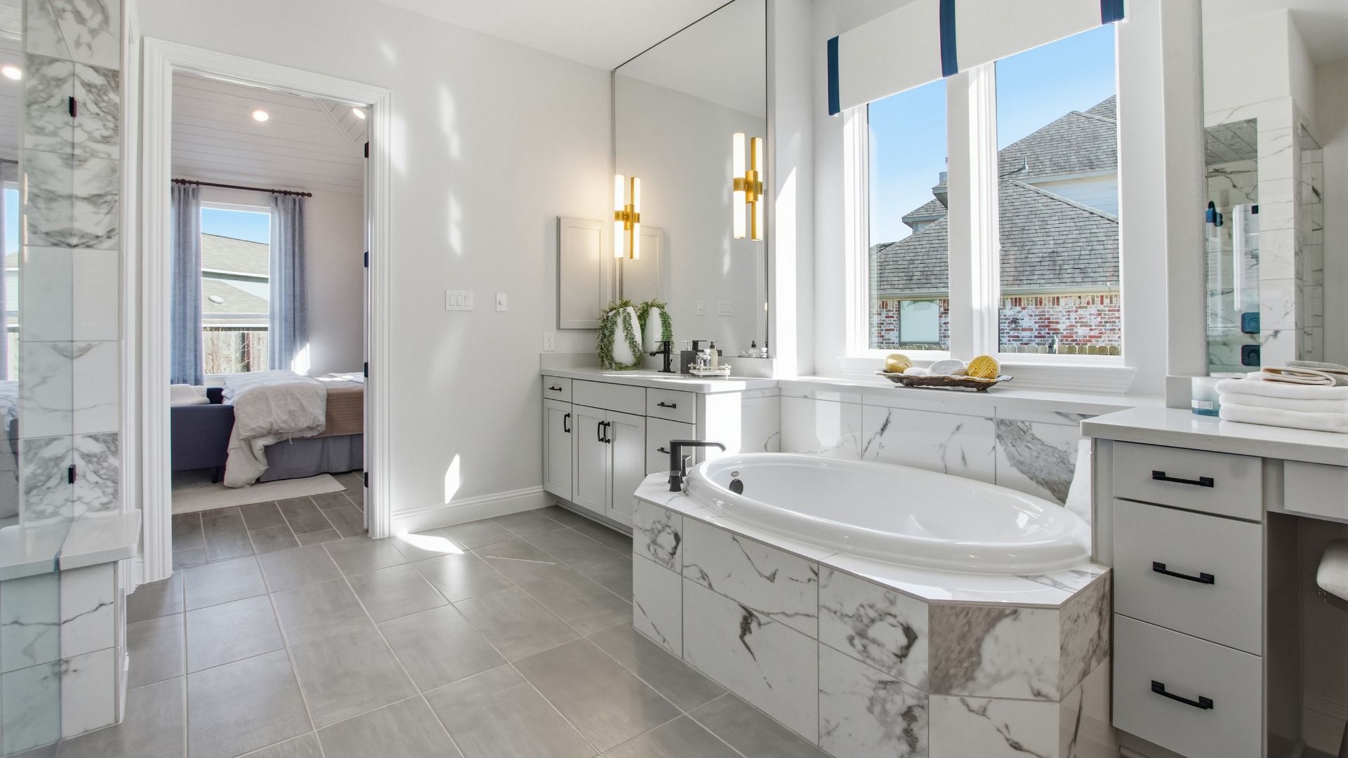 Indulge in this lavish Mostyn Manor Reserve bathroom, featuring a marble tub, dual vanities, and sleek modern fixtures.