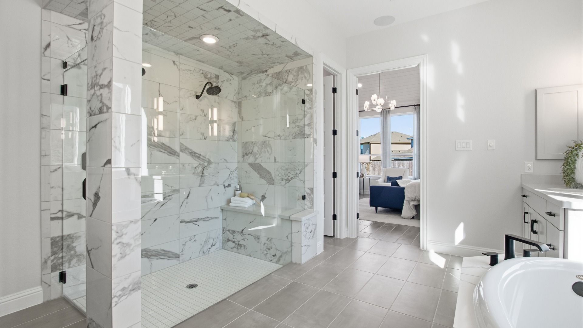 Experience elegance with floor-to-ceiling marble tiles and frameless glass shower in Mostyn Manor Reserve.