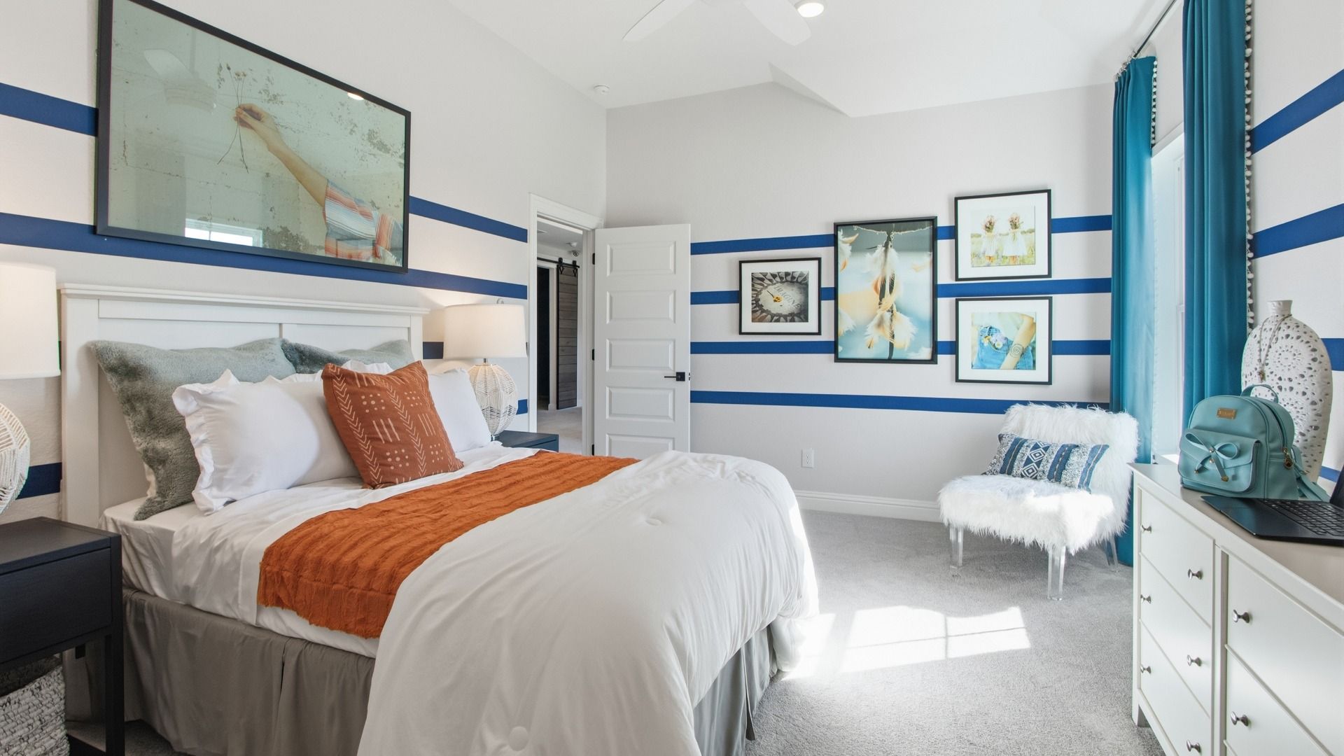 Generously sized guest room with decorative trim and abundant sunlight