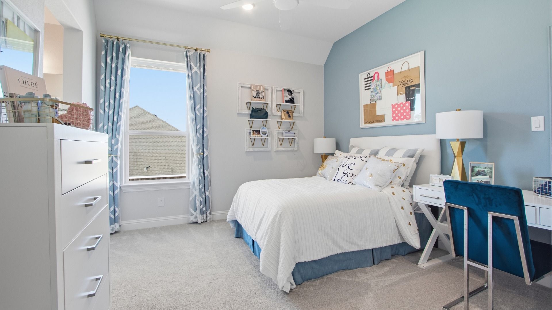 Generously sized guest room with decorative trim and abundant sunlight