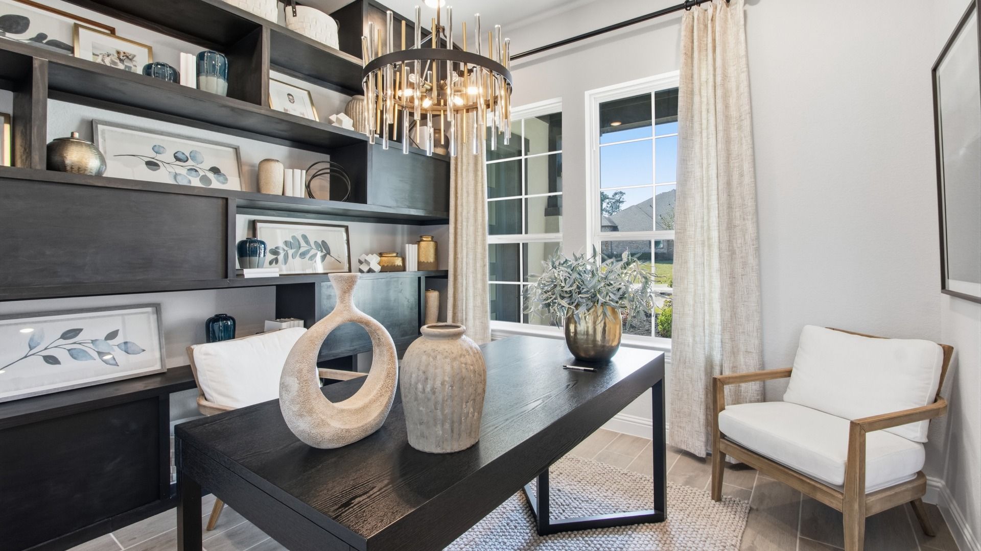 Chic study with wood shelving and crystal chandelier