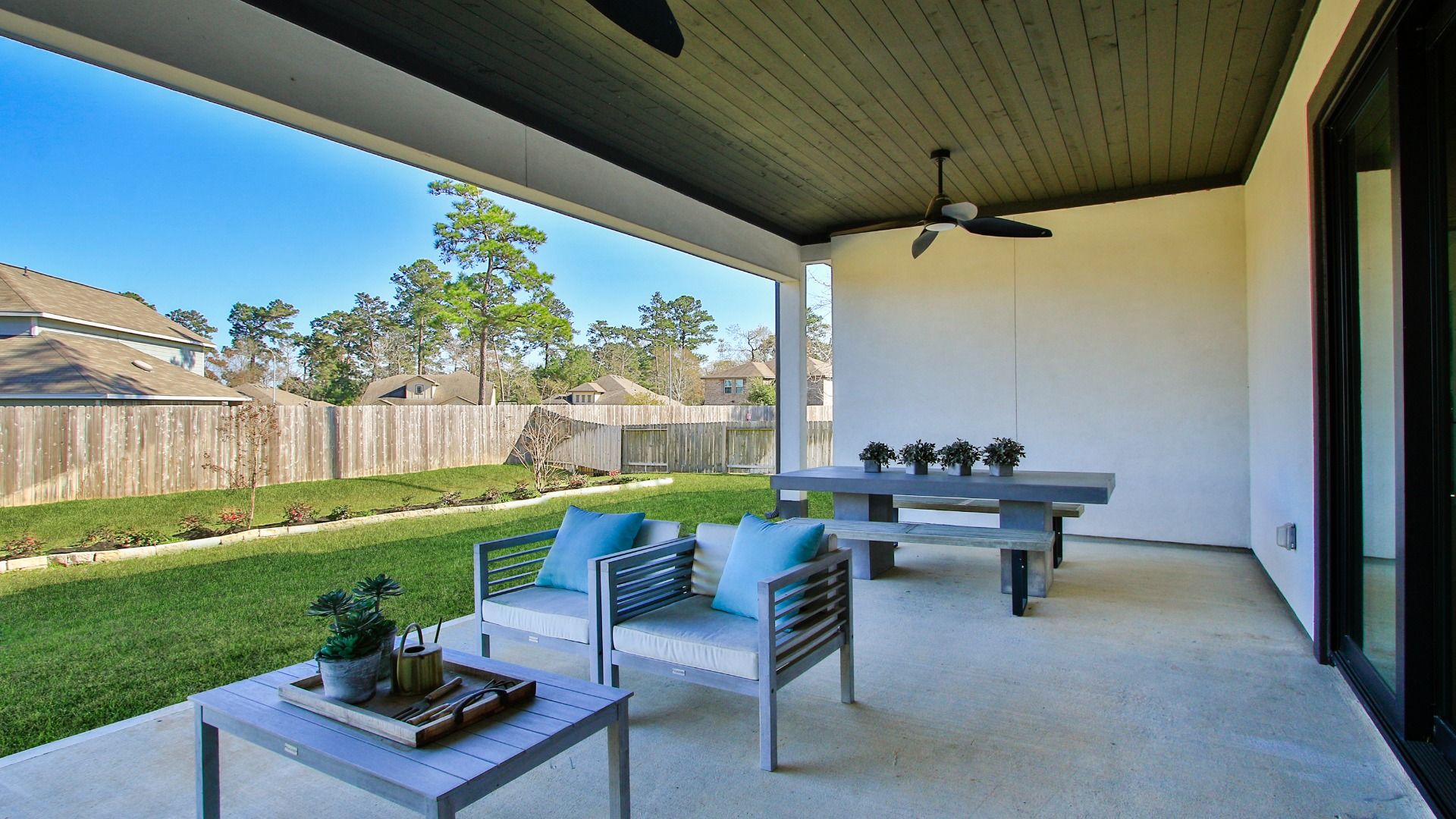 Oversized covered patio with two fans and great view of oversized homesite