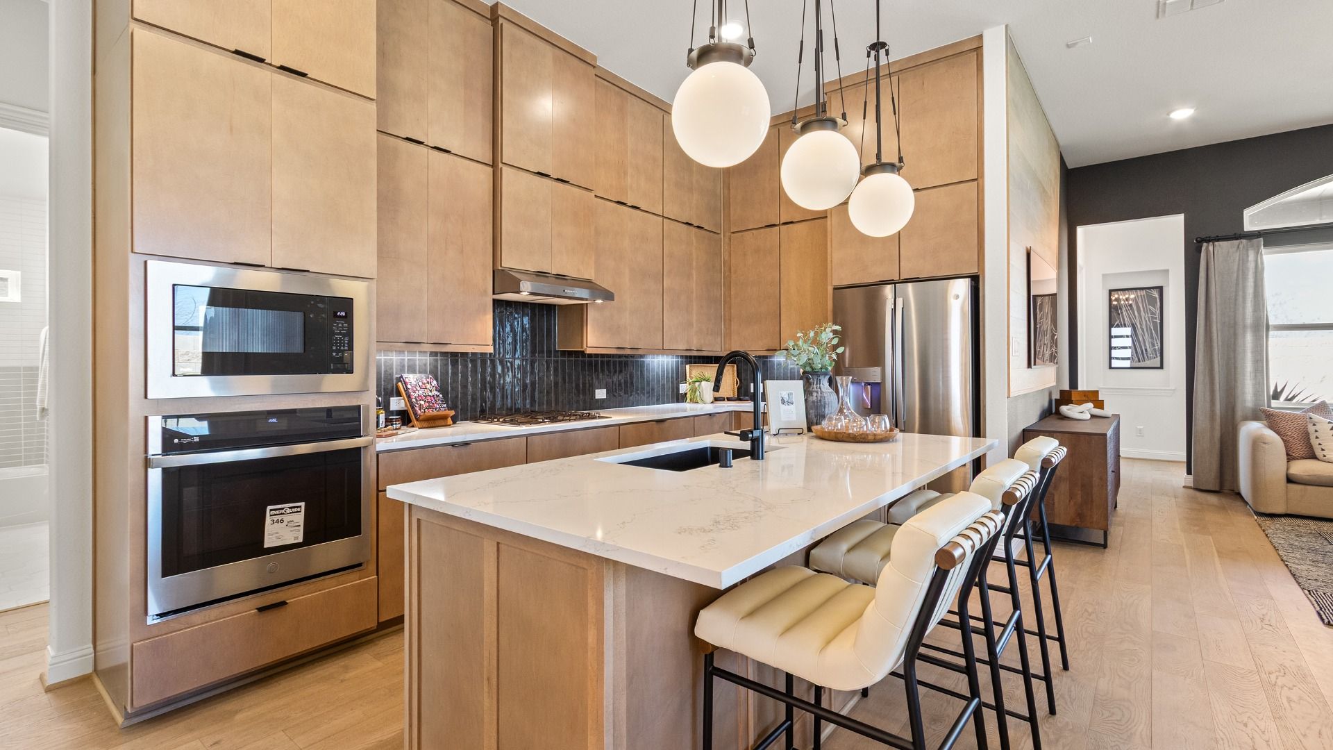 Discover the allure of custom wooden cabinetry and sleek white countertops in River Ranch's modern kitchen.