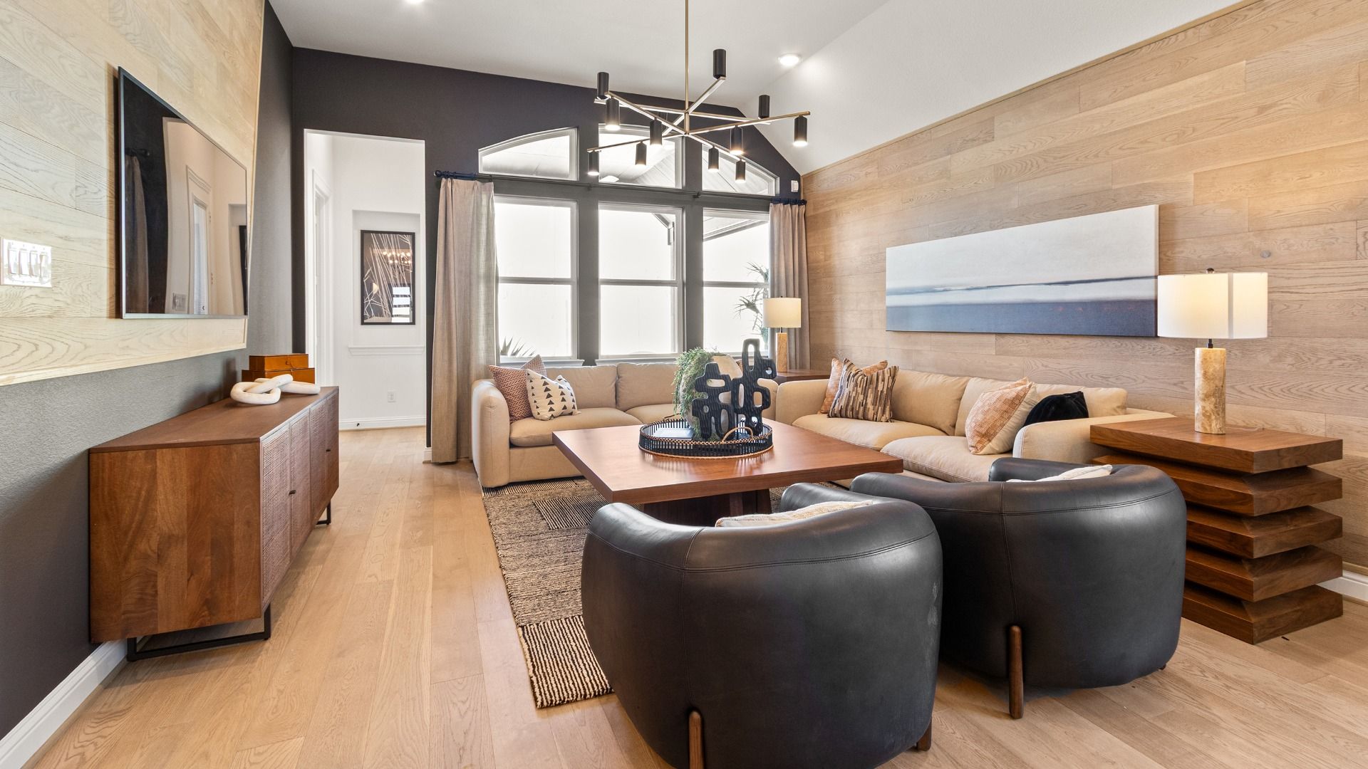 Elegant living room features wood accents and sleek lighting, offering style and comfort in River Ranch.