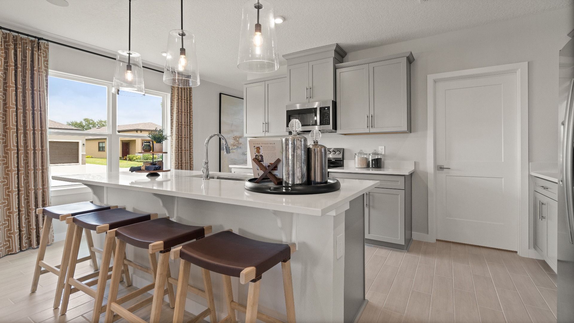 Farmhouse style Kitchen in this New Construction Home in Winter Haven Florida by DRB Homes the Jupiter in Willowbrook North