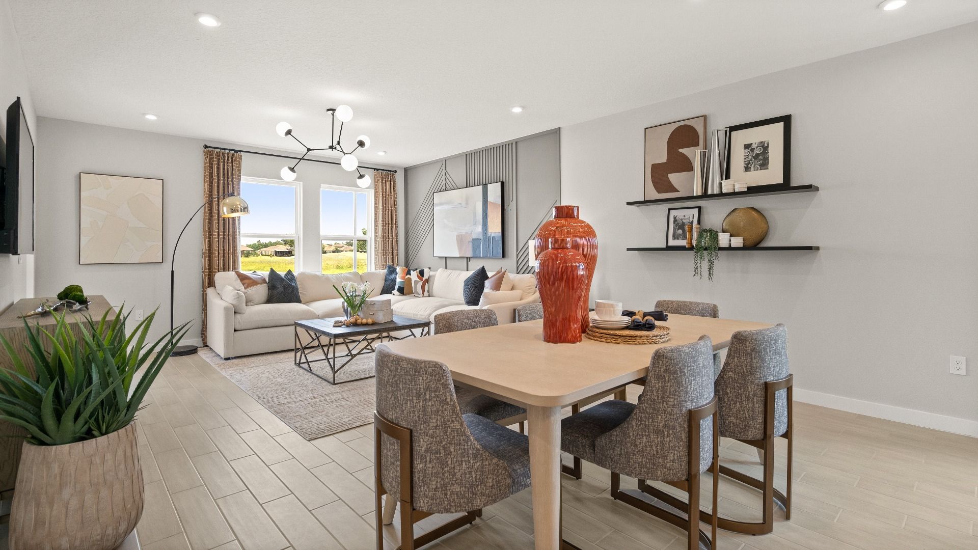 Decorated Living Area and Dining Area in this New Construction Home in Winter Haven Florida by DRB Homes in Willowbrook North