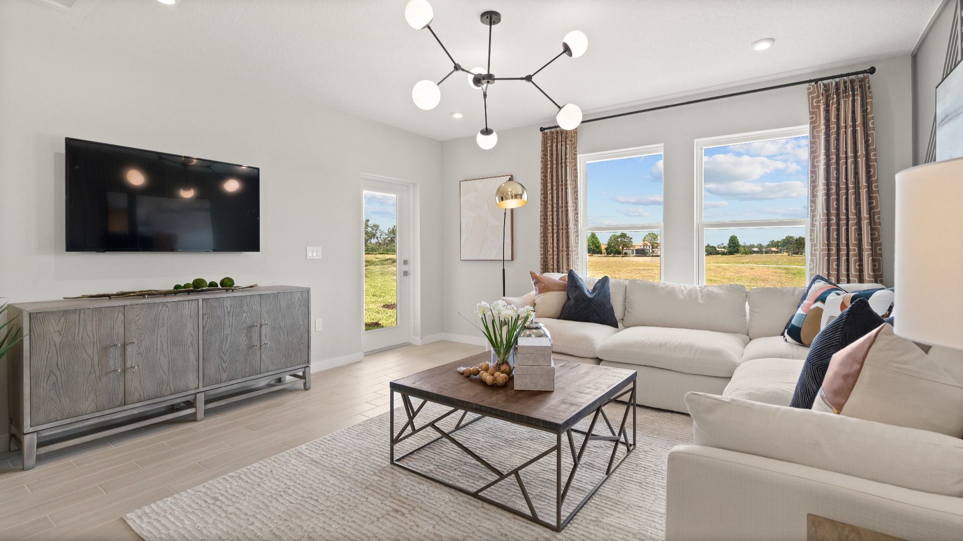 Modern Decorated Living Area with in this New Construction Home in Winter Haven Florida by DRB Homes in Willowbrook North