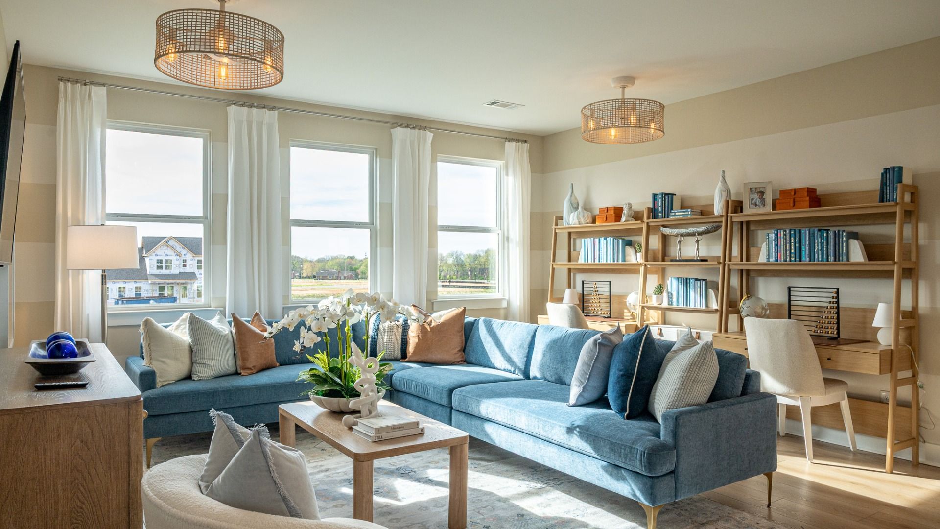 Bonus room with large sectional, TV, and desk areas