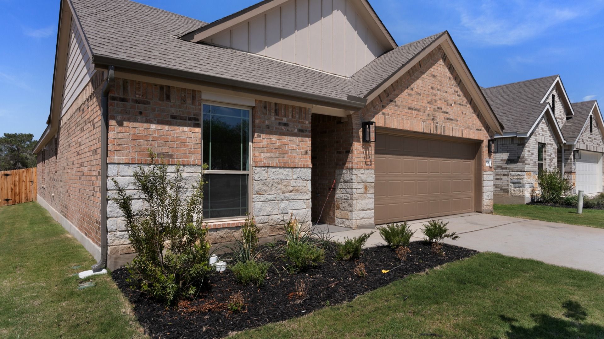 Professionally landscaped yard, 3 sides masonry, stone/rock accents