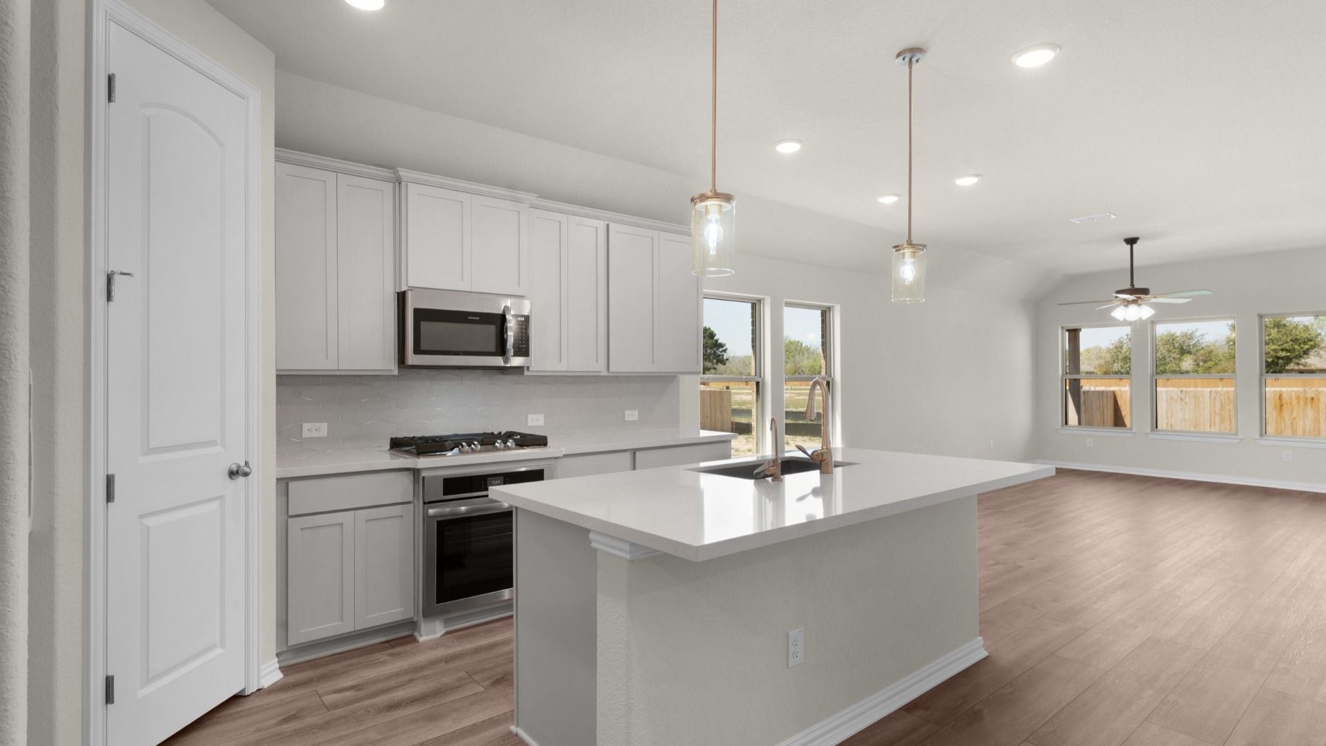 Kitchen featuring pendant lighting, corner pantry, 42" cabinetry, center island, stainless steel gas appliances.