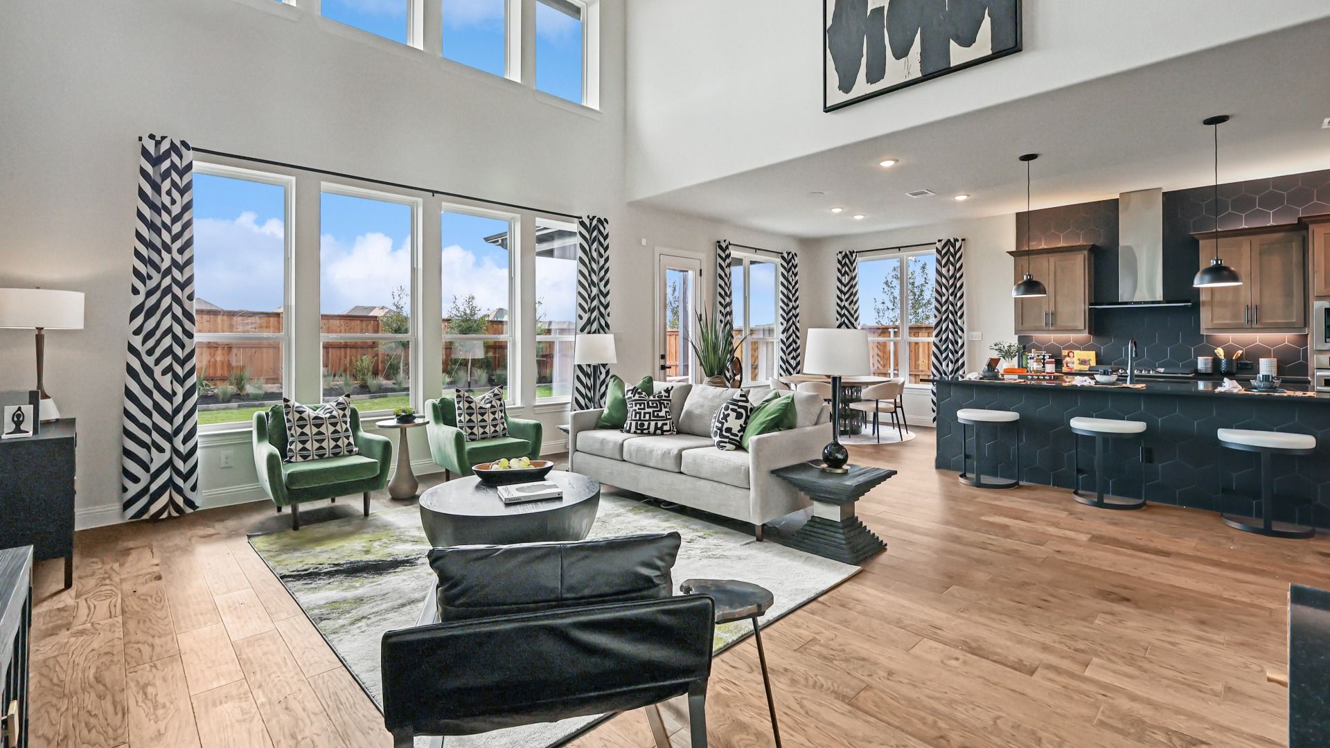Soaring ceilings and expansive windows amplify light and space, accentuated by chic decor in Green Meadows.