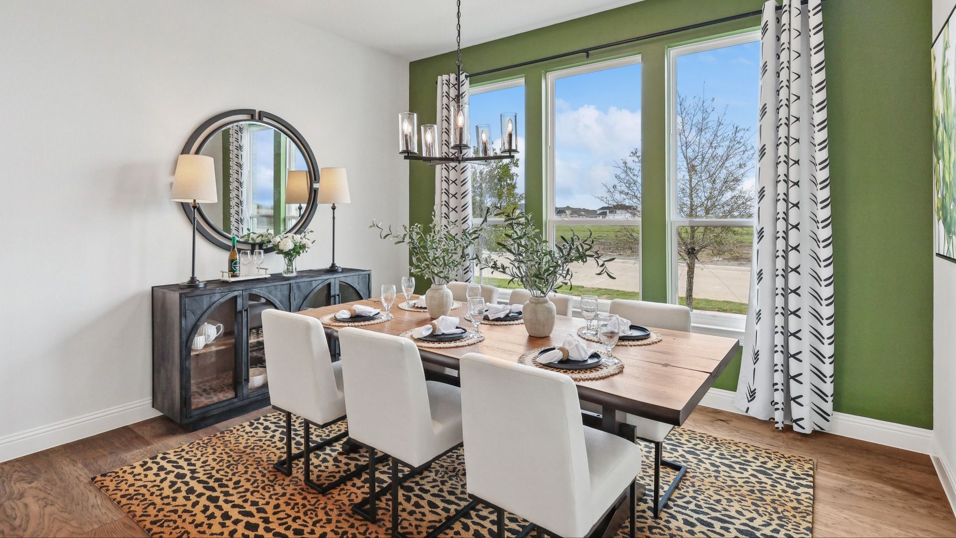 Experience refined elegance with a wood table, plush seating, and expansive windows in Green Meadows.