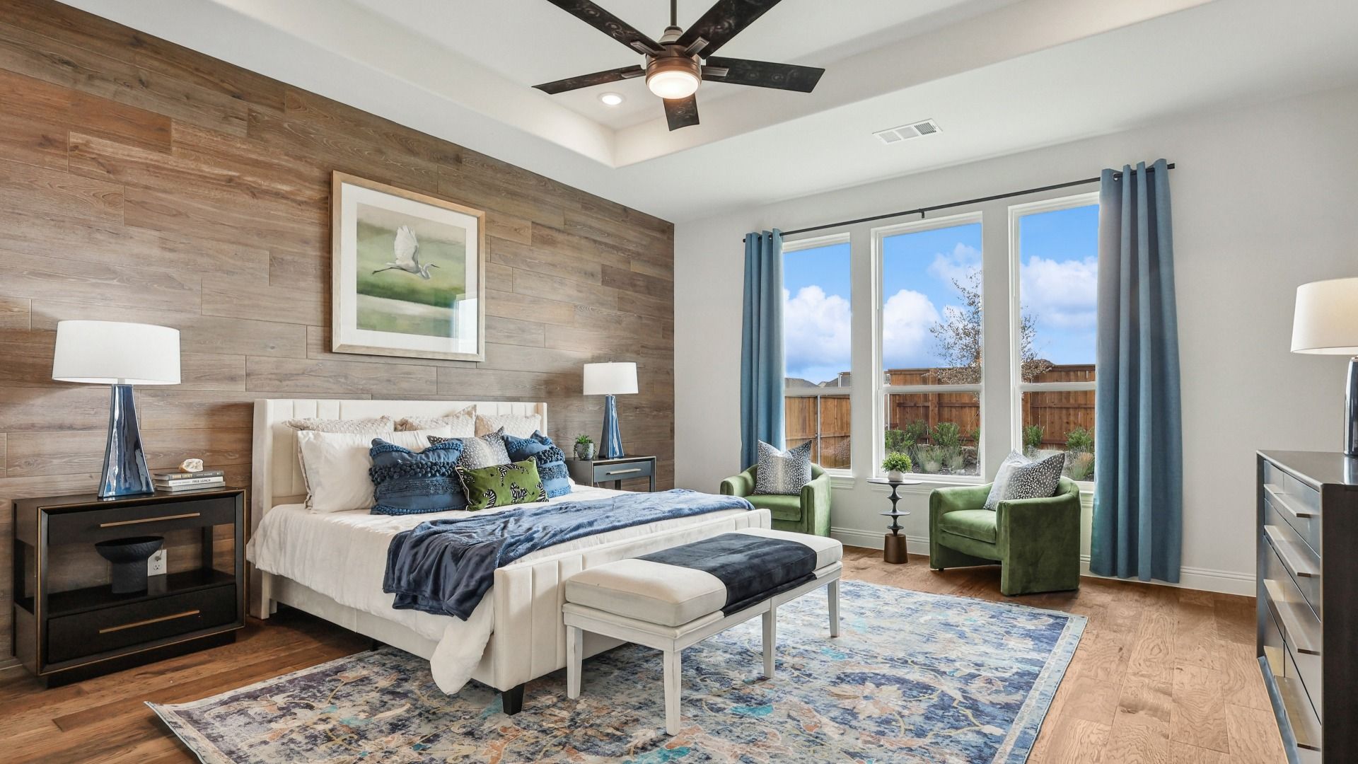 Experience sophistication with a wood accent wall, plush seating, and expansive windows. Green Meadows elegance.