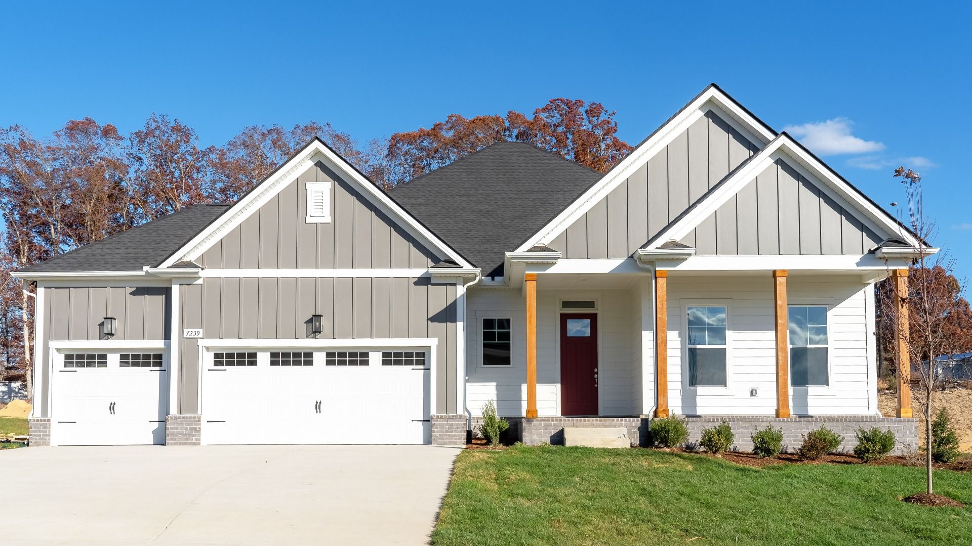 Exterior of single-story home with 3-car garage and covered front porch