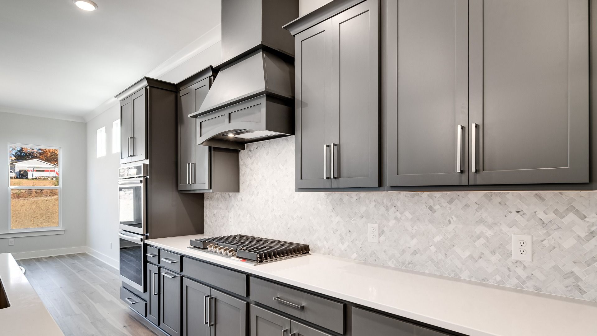 Gas range with designer backsplash and gray cabinetry