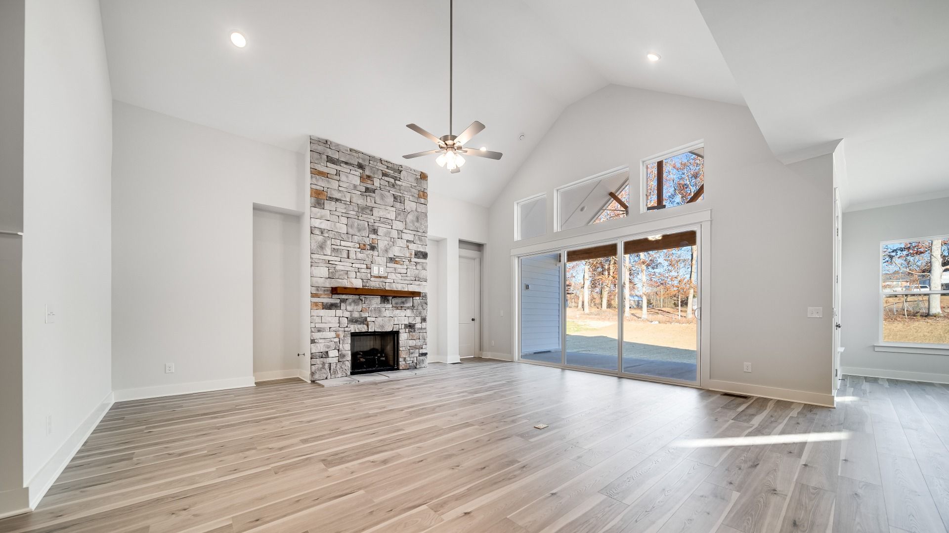 Large great room with vaulted ceilings and stone fireplace