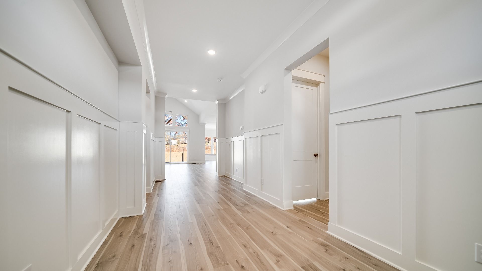 Front door entryway with wood floors and white trim accents