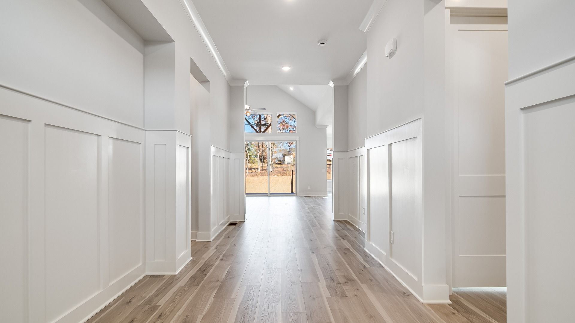 Front door entryway with wood floors and white trim accents