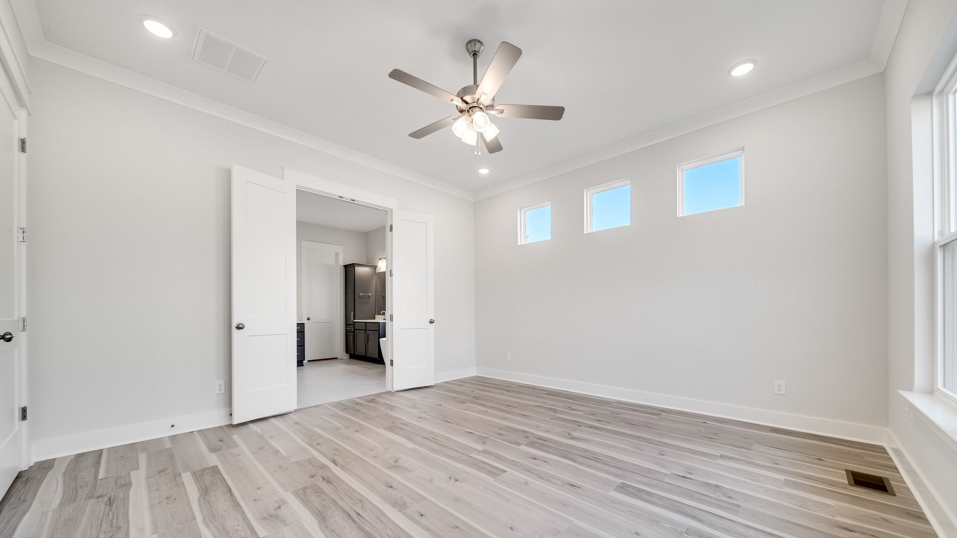 Primary Bedroom with French doors leading to en-suite bathroom