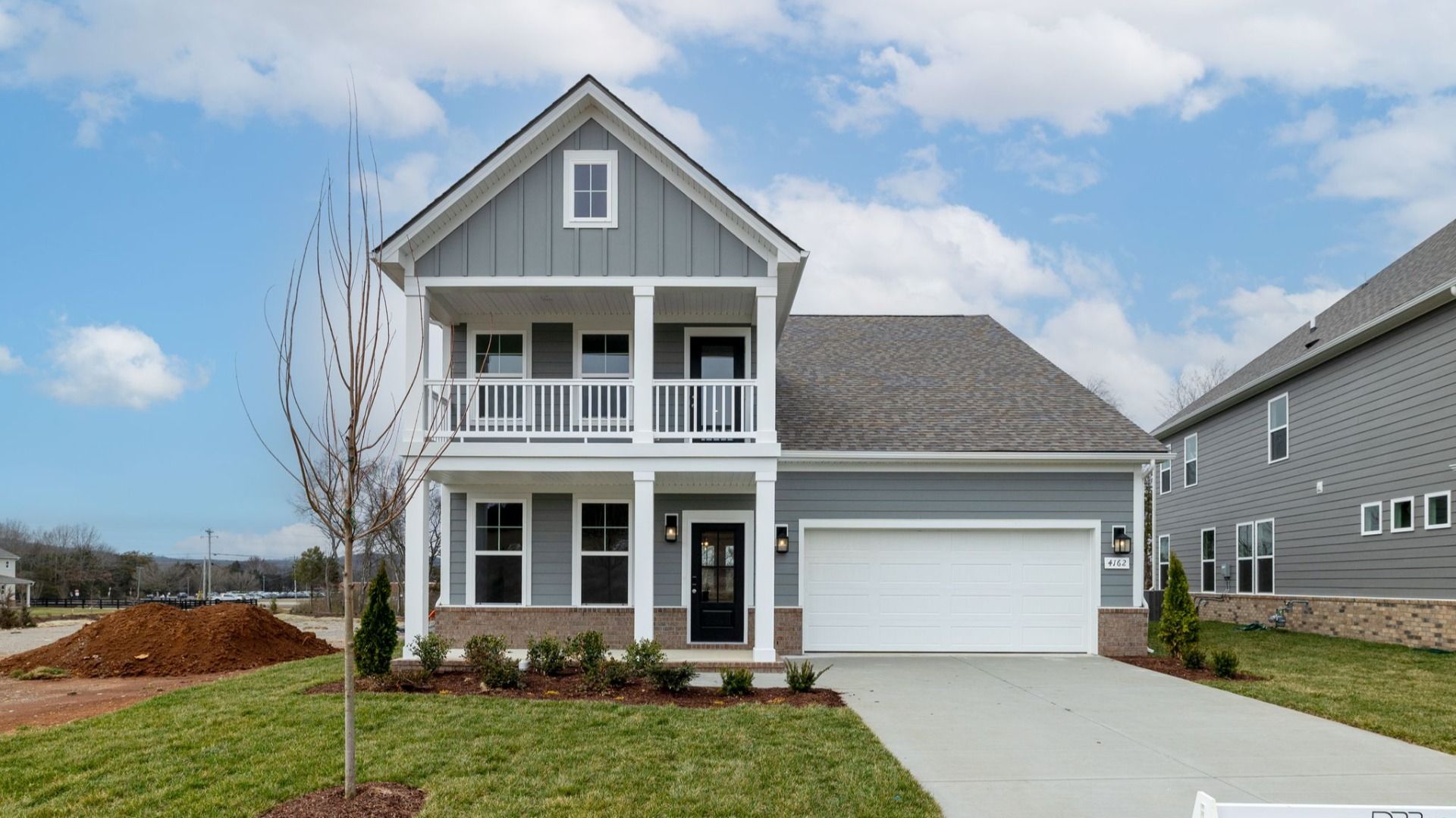 Exterior of home with covered front porch and balcony