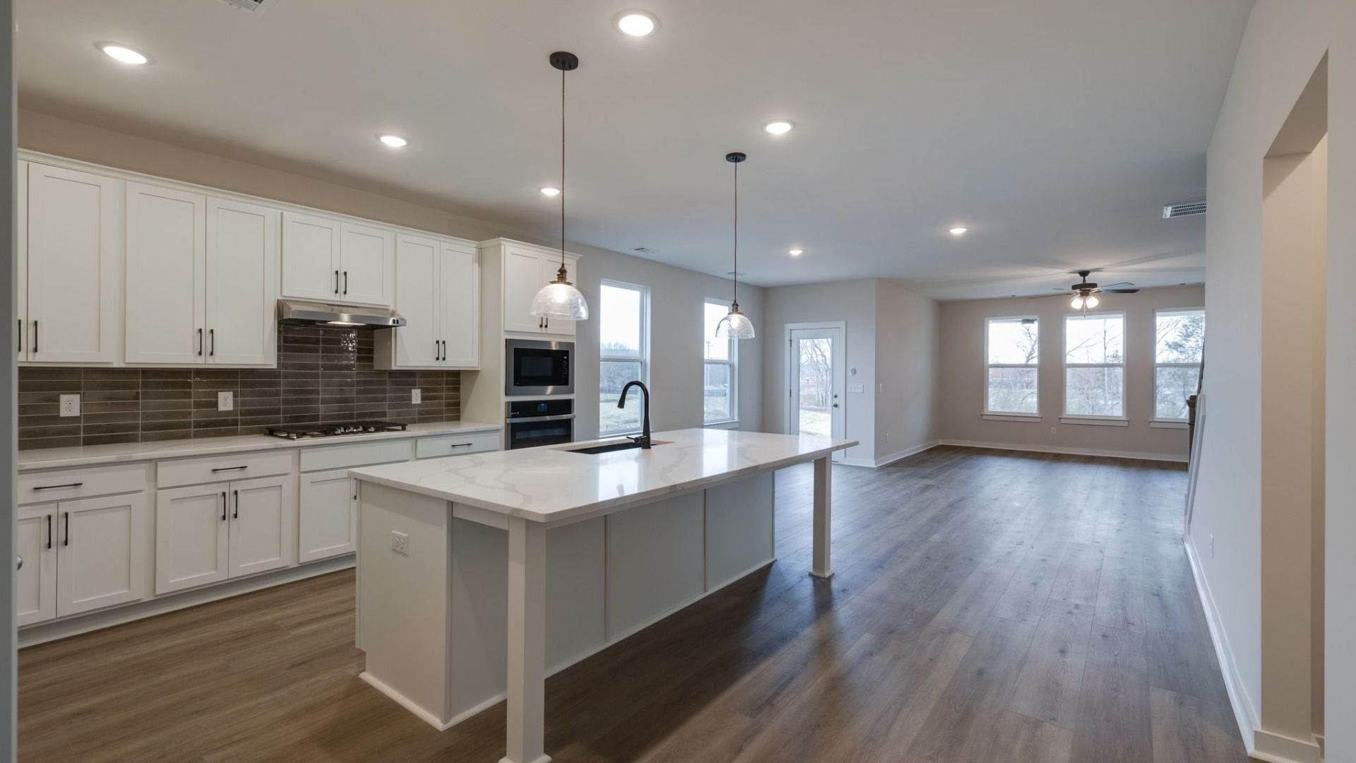 Open concept first floor with kitchen, dining area, and gathering room