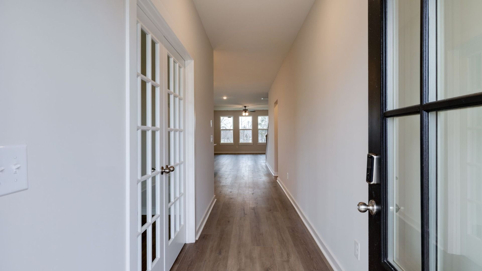Entryway to home with study doors and hallway to the main living areas