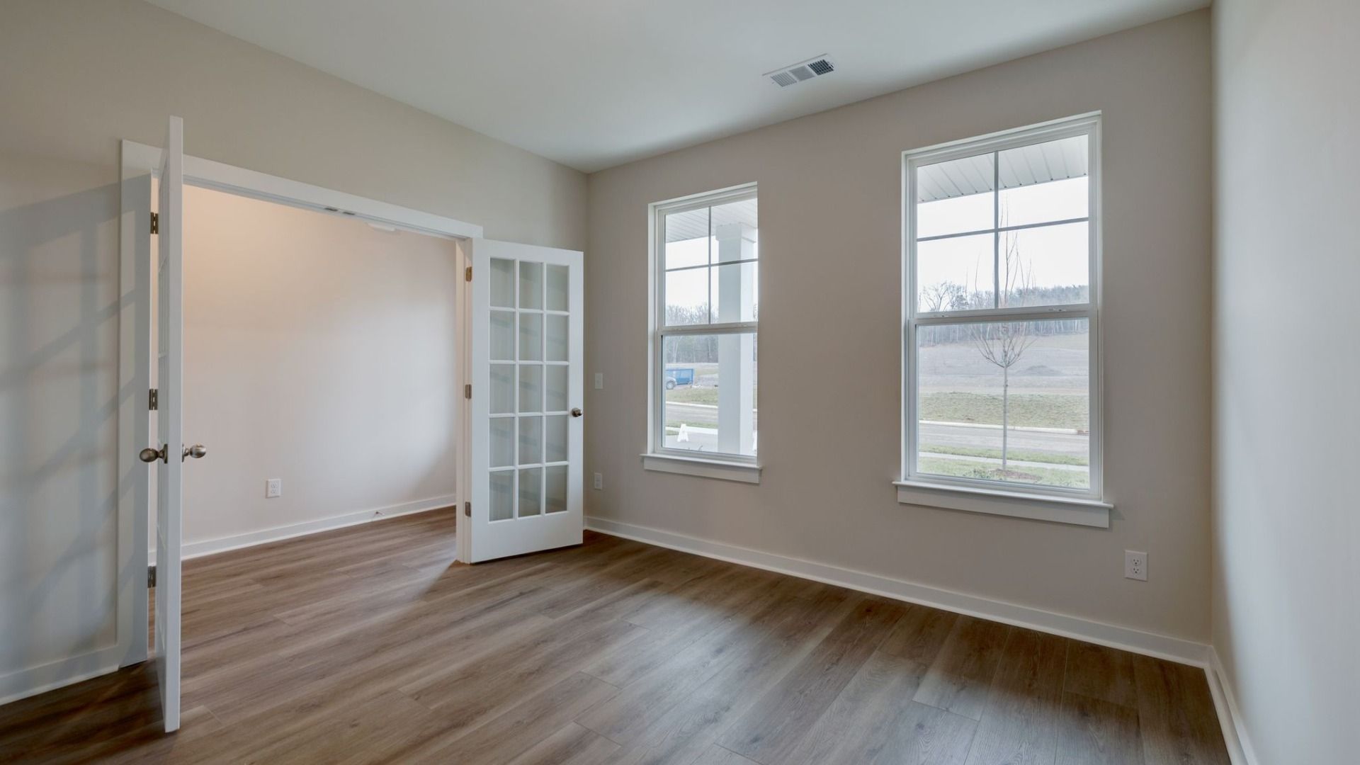 Dedicated study with glass pane french doors and bright windows